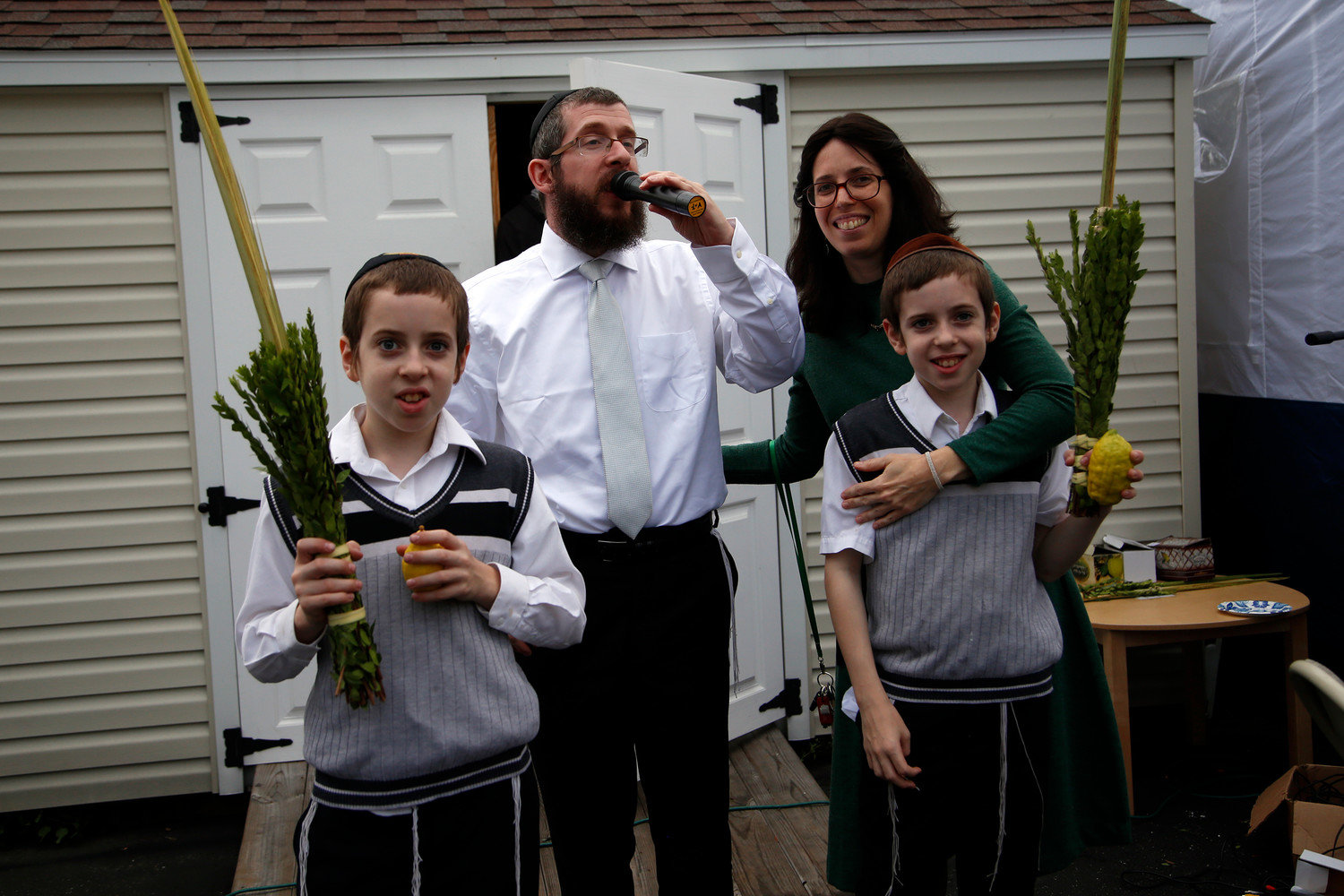 Rabbi Shimon Kramer and Rabbanit Chanie Kramer and two of their sons.