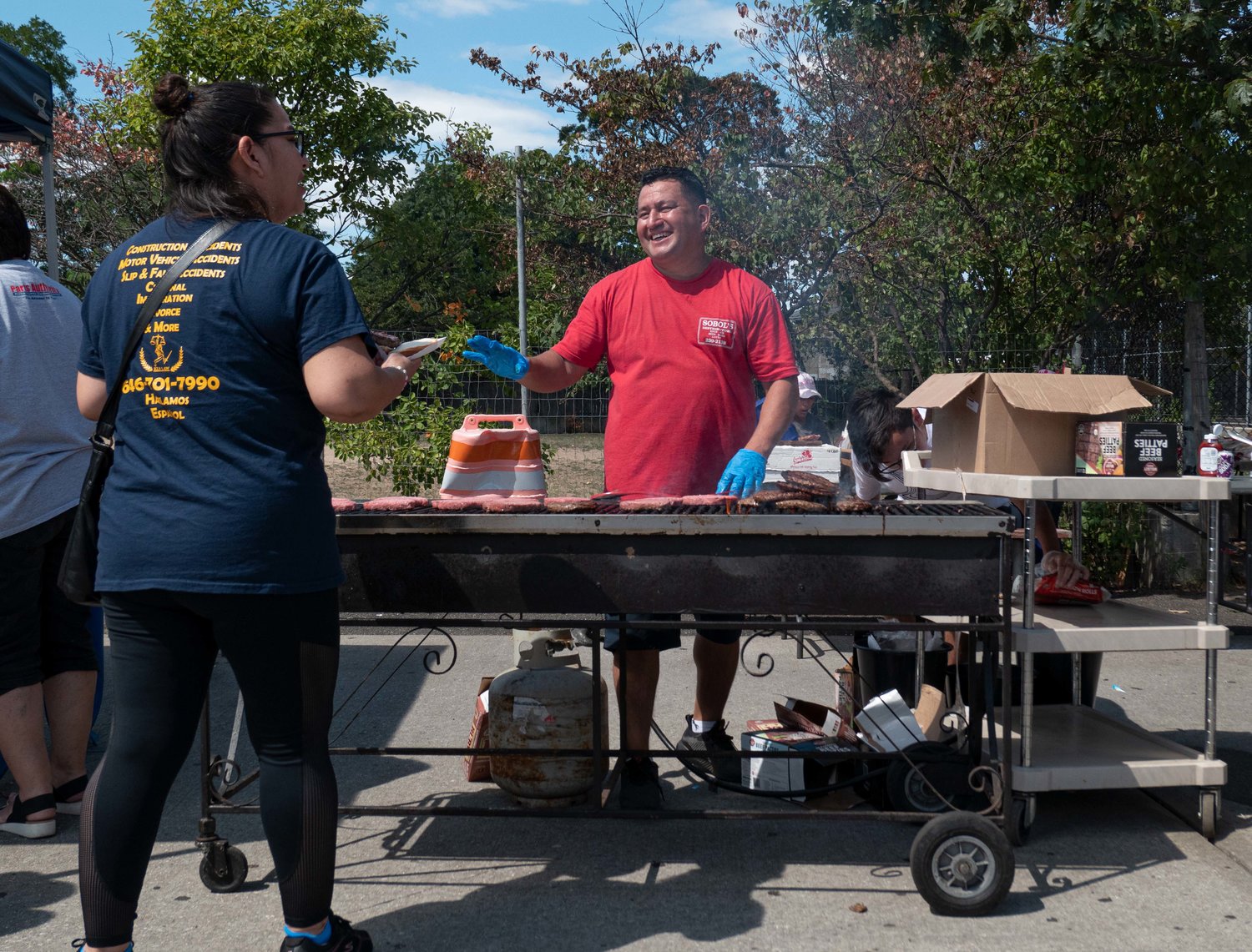 Byron Alavarado Valiente grilled and served the hamburgers at the annual Inwood Day festivities.    