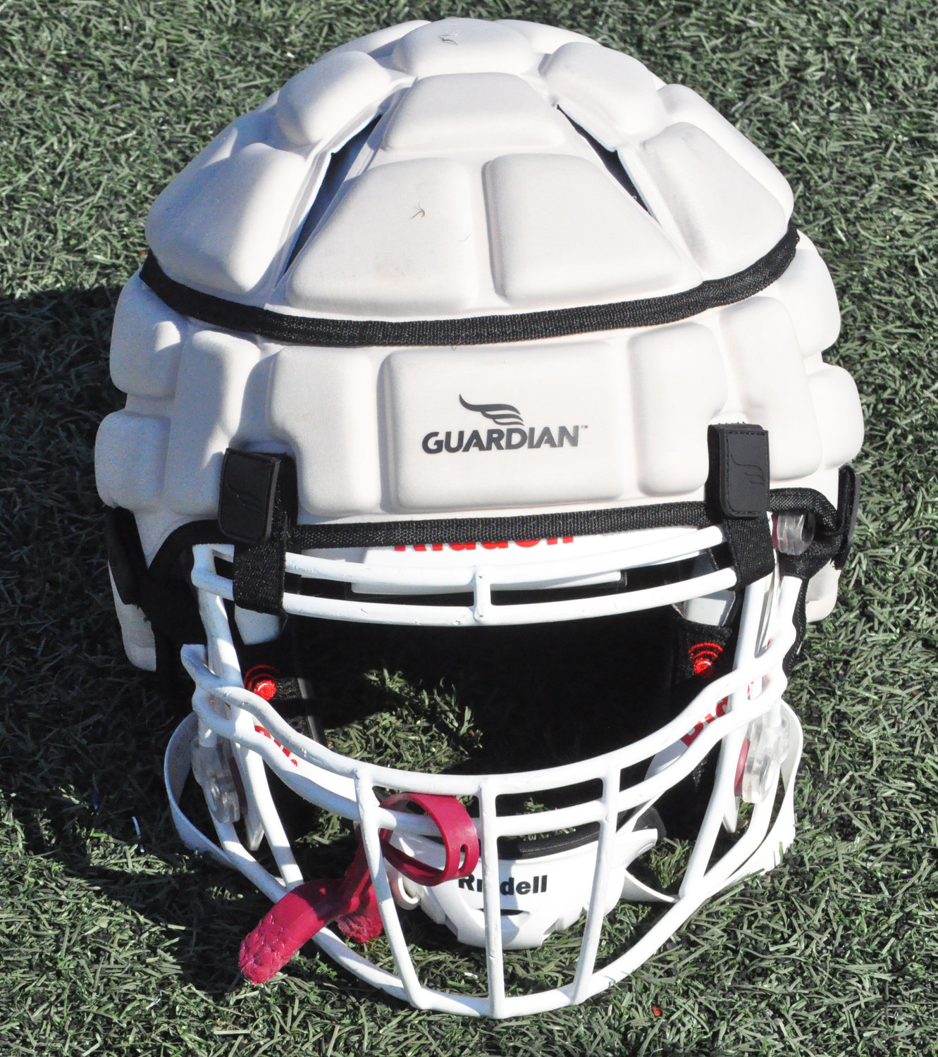 The caps reduce the force of impact a football player endures when they fall to the ground. It fastens onto the outside of the helmet with Velcro straps.