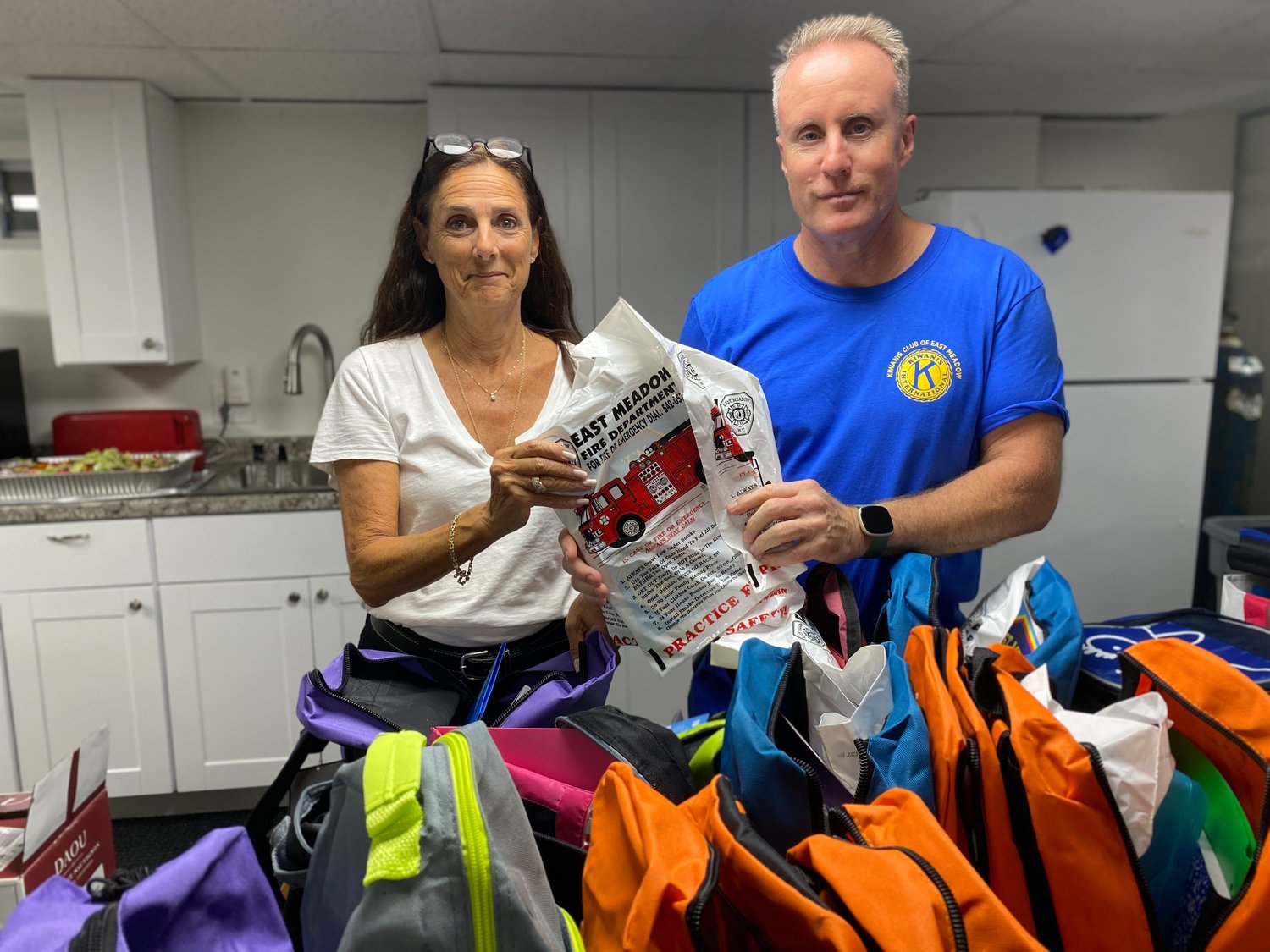 Diane Krug and Brian O’Flaherty helped fill backpacks on Aug. 23 at the East Meadow Kiwanis club’s ‘Pack a Backpack’ event. The backpacks will go to children in need in the district.