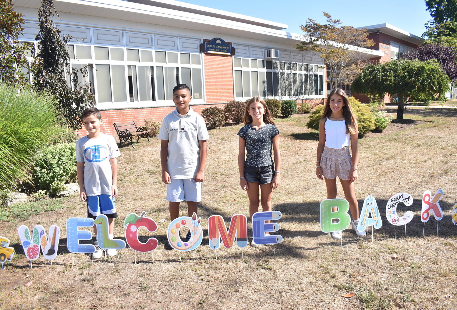 John G. Dinkelmeyer Elementary School sixth graders, from left, Lucas Maresco, Aaron Boodhram, Garifalia Vatougios and Kaylee Gangi stopped by the first day photo station on Sept. 1.