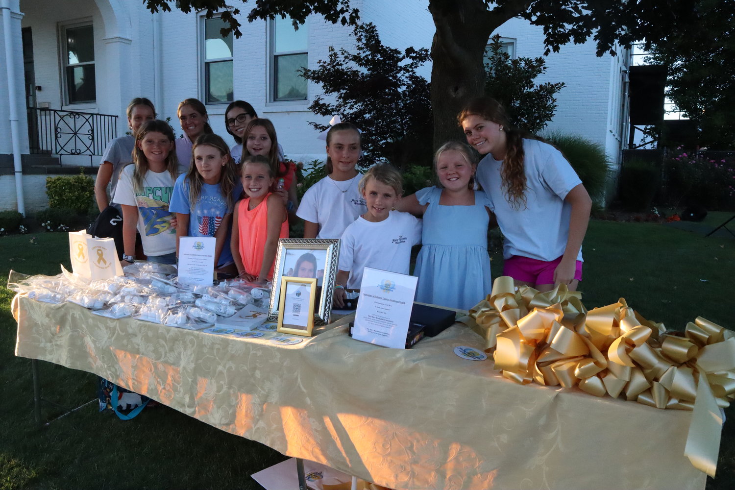 Children pitched in to help raise money for the Mary Ruchalski foundation by selling gold bows and luminarias to “Light it Up Gold” for pediatric cancer awareness.