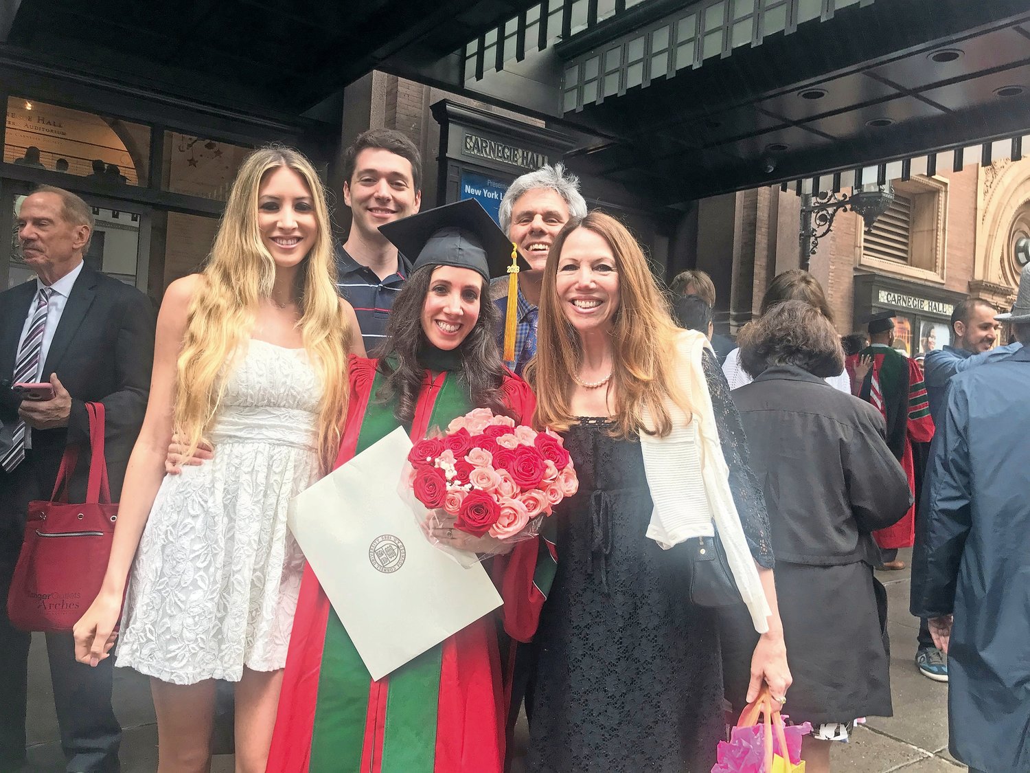 Berman’s medical school graduation in 2018 with her parents Pamela and Martin, sister Genny, and now husband, Glenn.