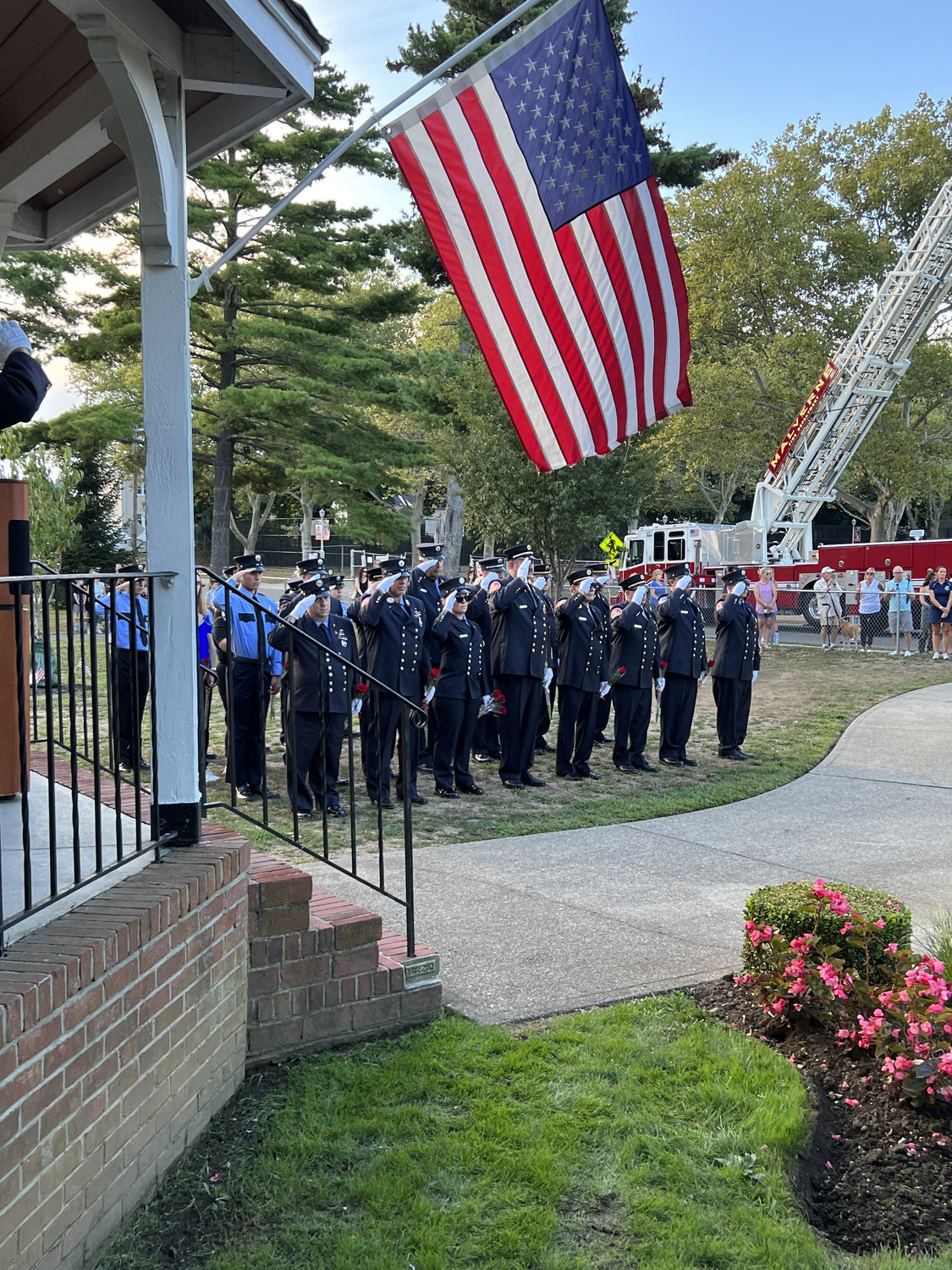 Firefighters from the Franklin Square & Munson Fire Department stood at attention during the 9/11 memorial service last Saturday across from Rath Park.