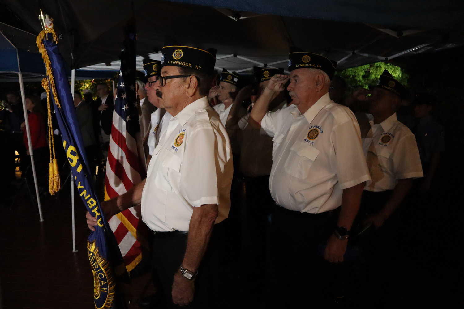 Members of Lynbrook American Legion Post No. 335 present the colors to start the ceremony on Sunday night