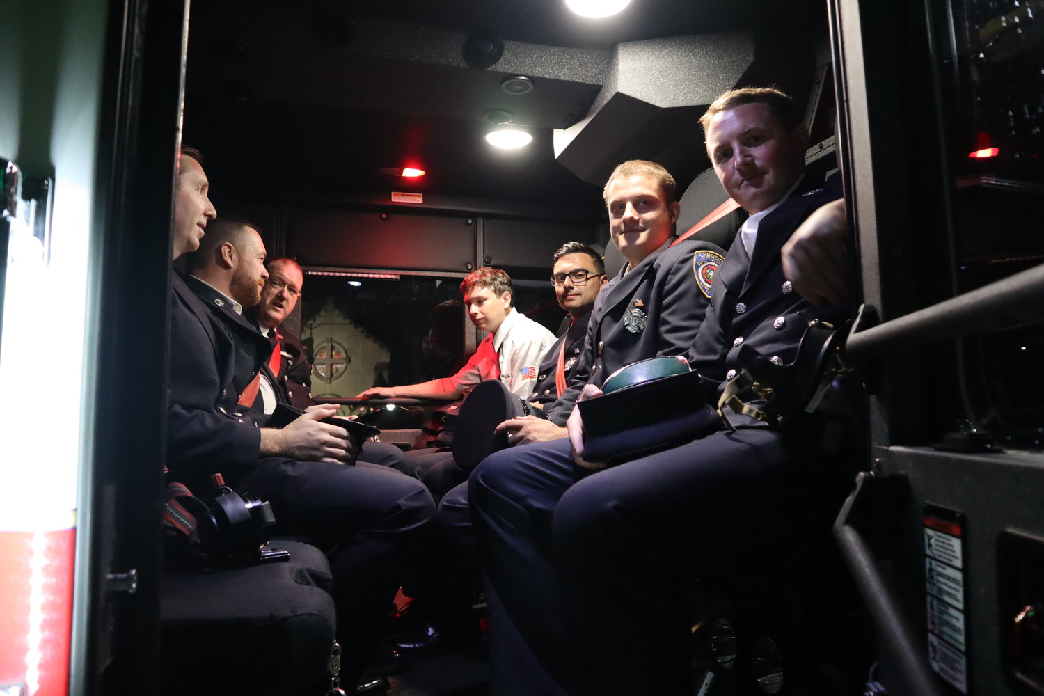 Lynbrook Fire Department’s Engine Company No. 1 strap themselves into the truck following the 9/11 ceremony.