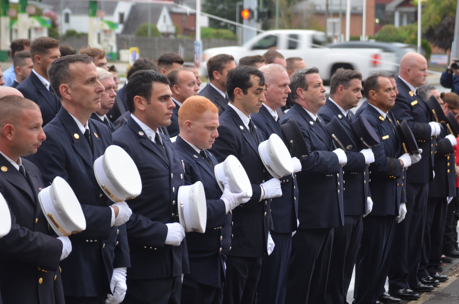 Firefighters in Merrick lined up, with their caps across their hearts, to commemorate the solemn day.