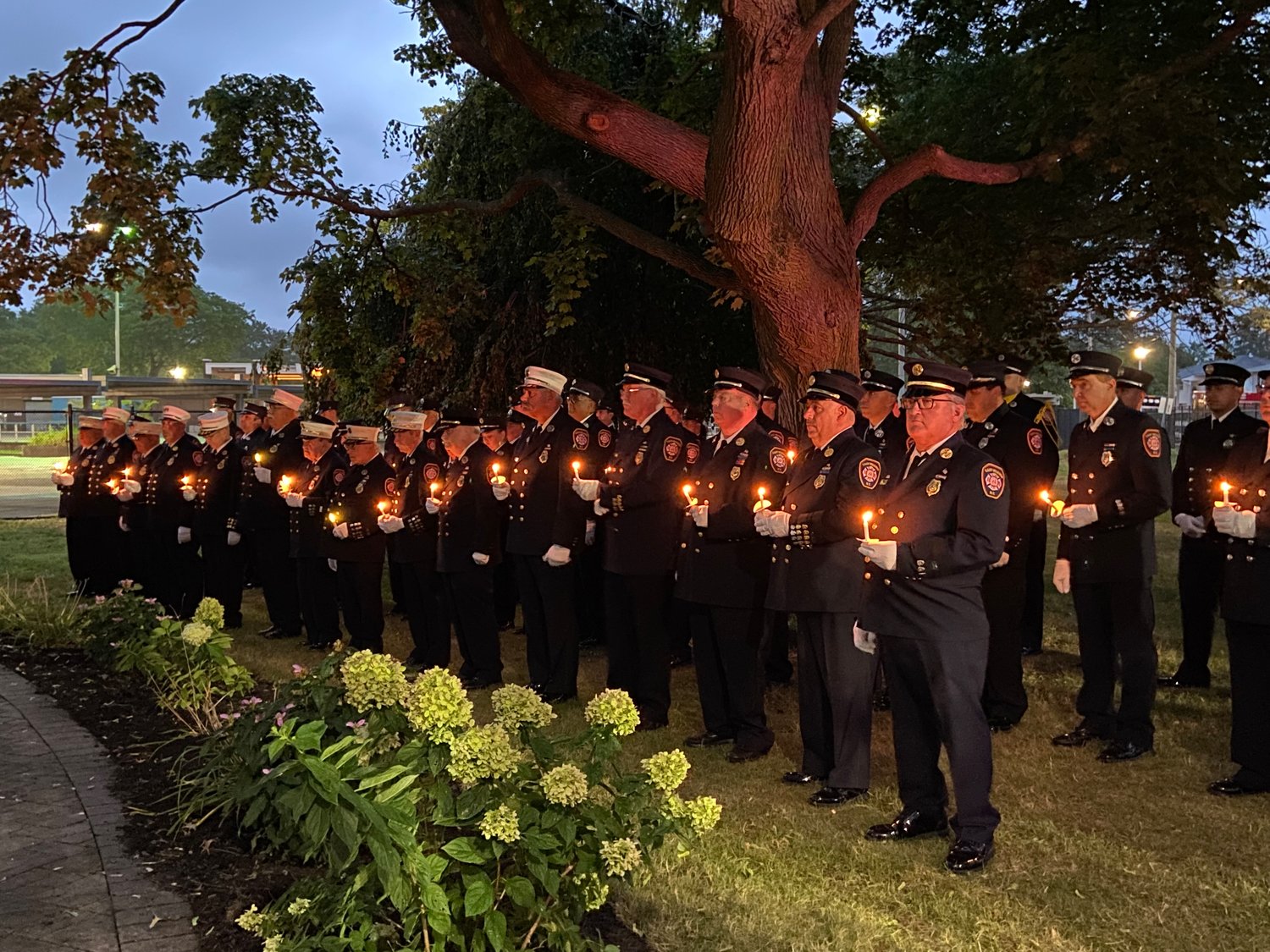 Members of the EMFD held their candles in honor of those who sacrificed their lives on 9/11 at the ceremony hosted by the fire department on Sept. 11.