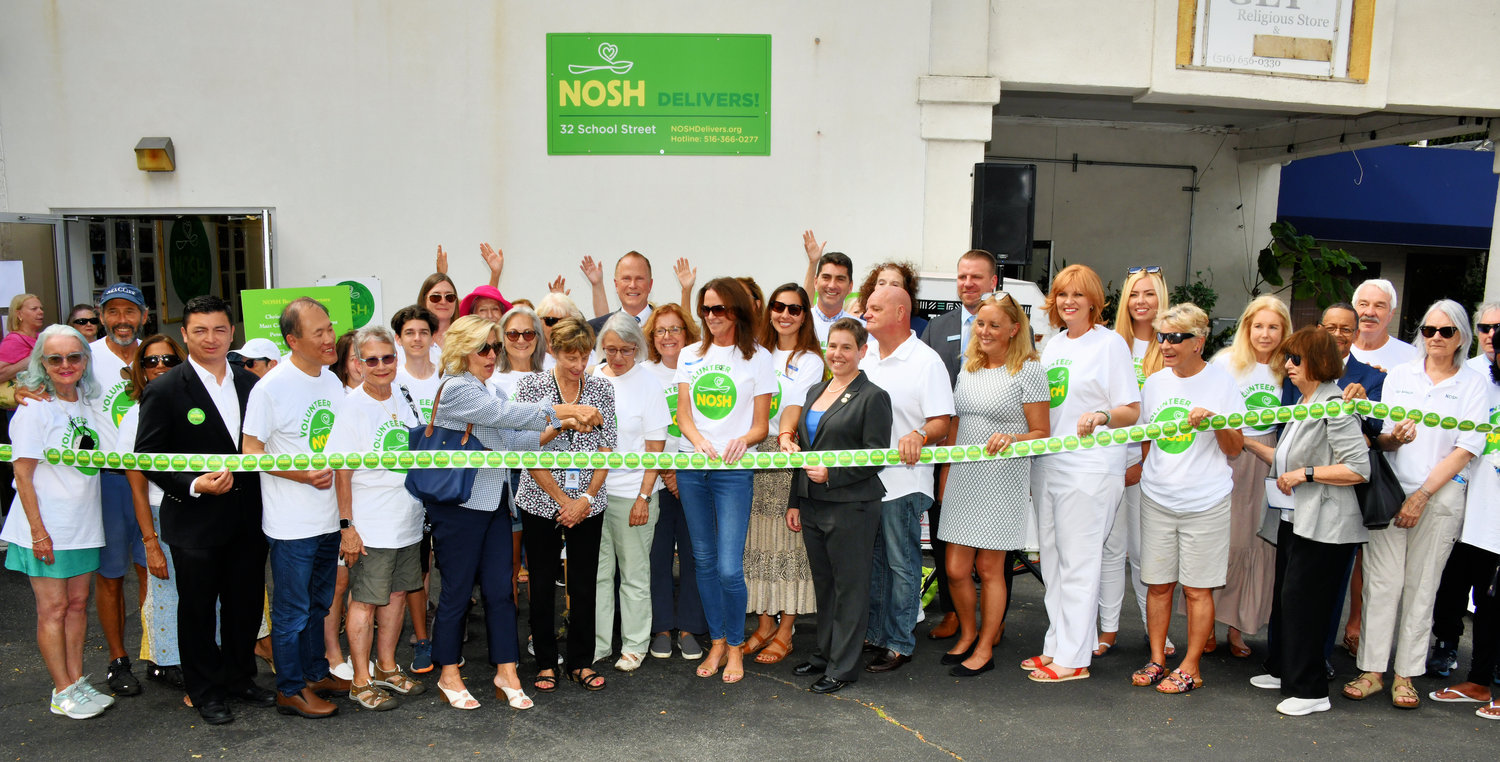 The ribbon cutting ceremony outside the entrance of NOSH's new headquarters on 32 School St. was attended by many residents, volunteers and officials who came to show their support to NOSH's new location.