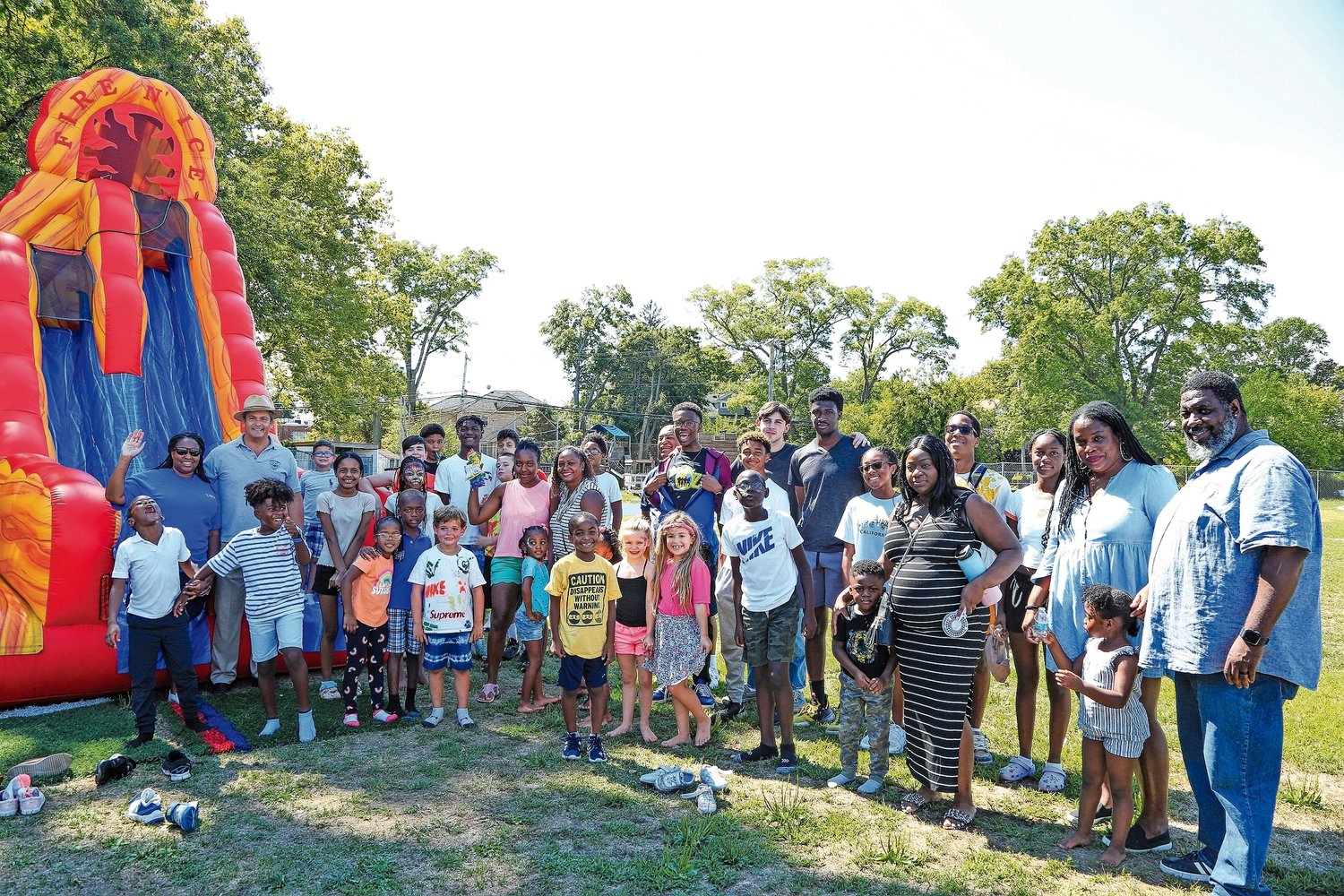 The inflatable slide attracted a large group of people at the Lawrence Woodmere Academy barbecue.