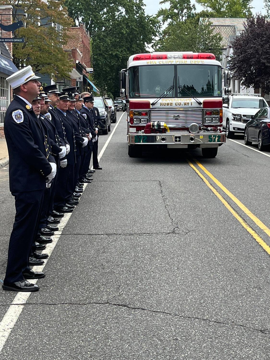 Members of the Sea Cliff Fire Department proudly stood by their company firetruck, highlighting the heroic efforts and sacrifices of first responders following the attacks.