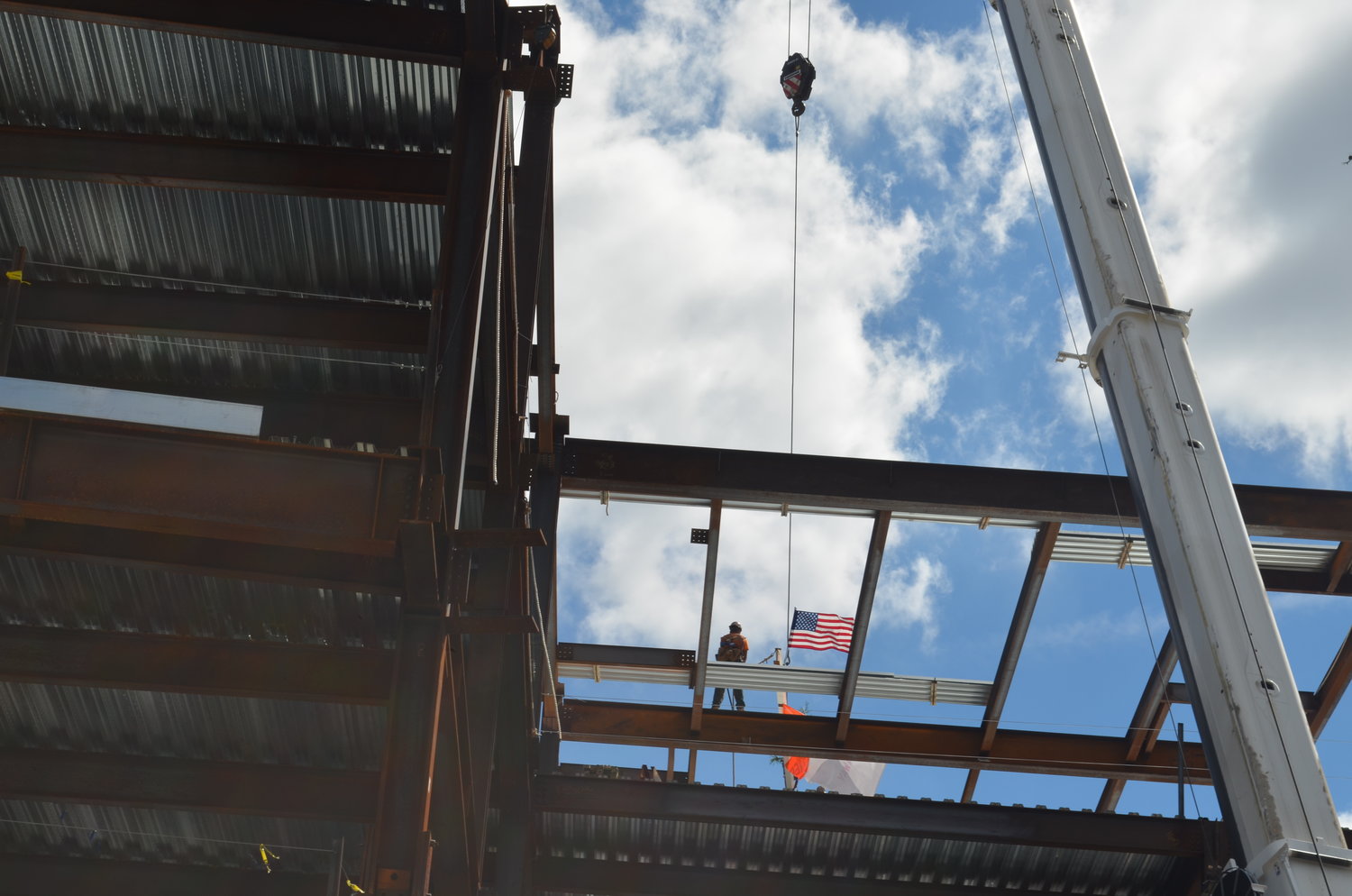 The last steel beam of the J Wing Patient Pavilion — the new $113 million facility constructed at Mount Sinai South Nassau in Oceanside — is hoisted into the air over the fourth floor. The facility is expected to open in 2024.