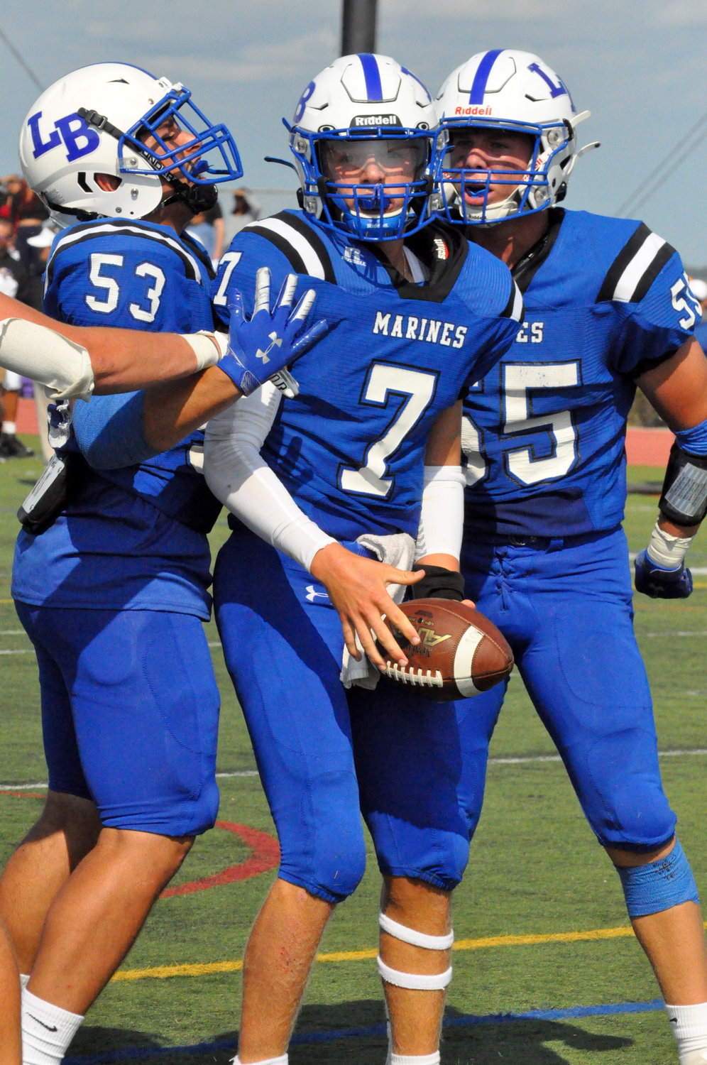 Long Beach quarterback Jeff Conway, center, celebrated his second-quarter touchdown run with Julian Mercado, left, and Nico Kanganis.