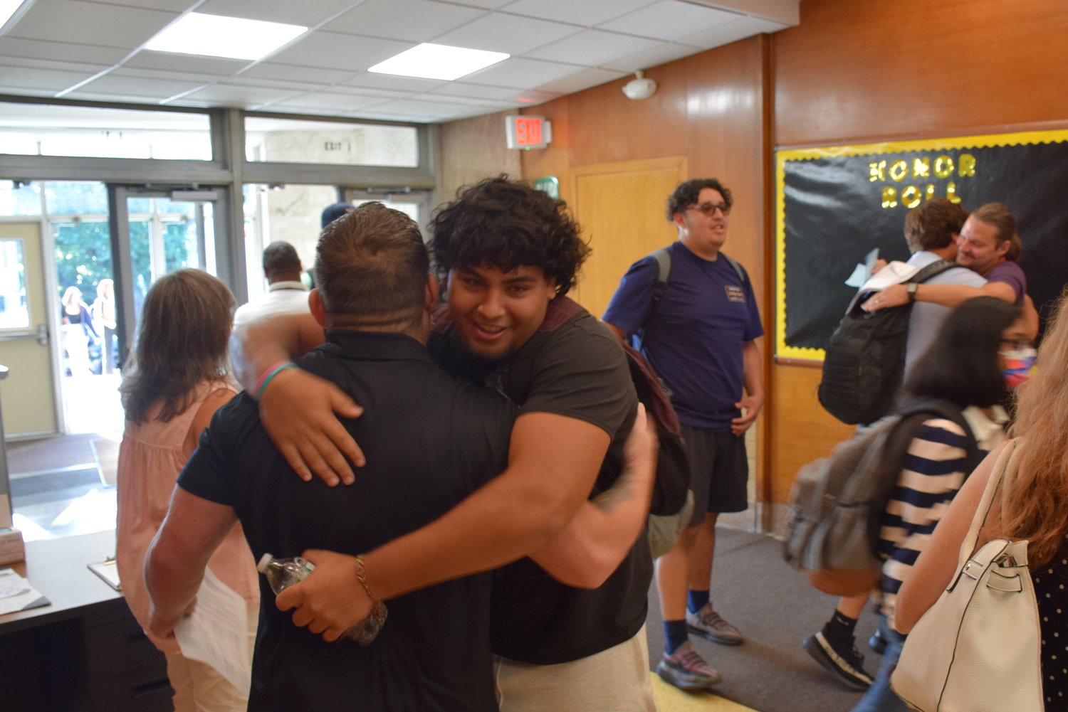Incoming senior Michael AbiAoun greeted phys. ed. teacher Rob Gewirtz with unbridled enthusiasm on the first day of classes at the new West Hempstead Secondary School on Sept. 1.