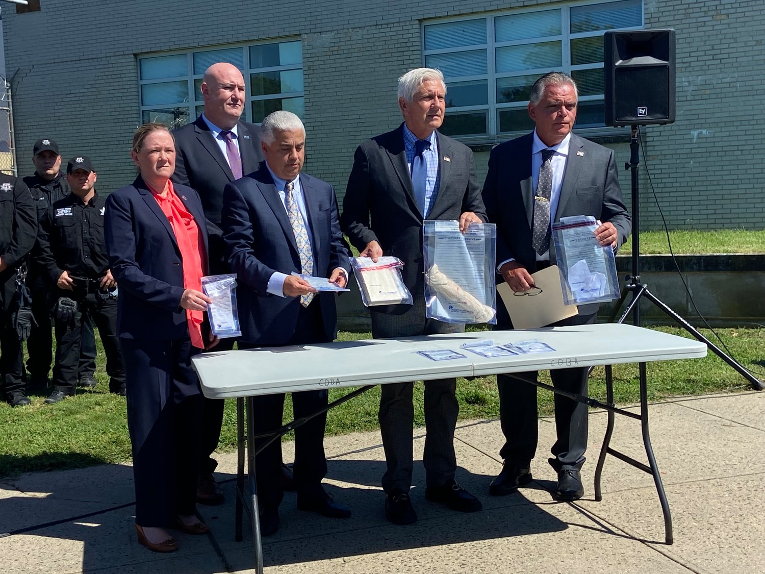Blakeman, second from right, with officials from the Nassau County Correctional Center, displayed the contraband that “Operation Clean Slate” turned up in the jail. Items included weapons and drugs.