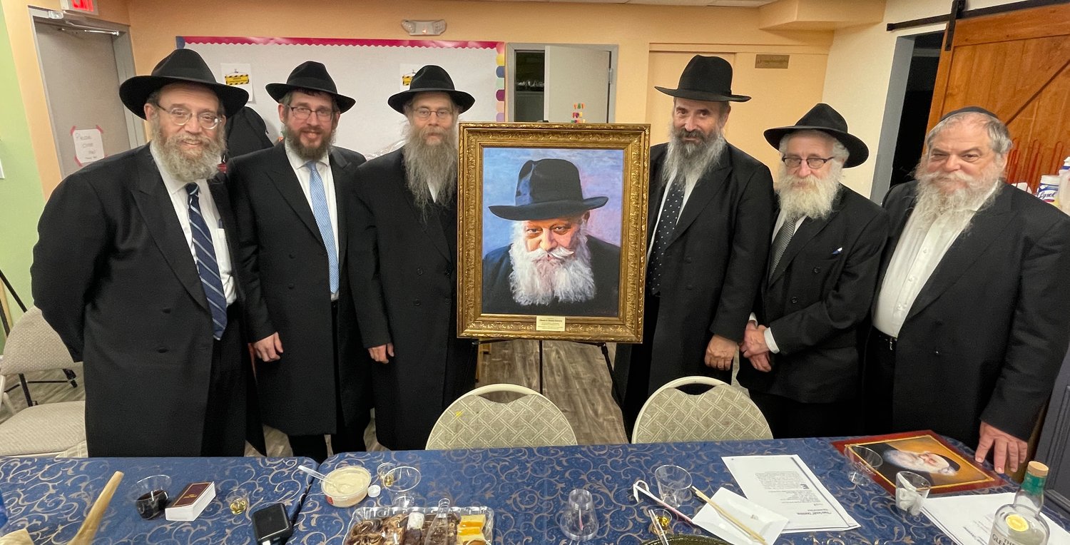 Rabbi Leibel Baumgarten, Rabbi Shimon Kramer, Rabbi Chona Gewirts, a photo of the Lubavitcher Rebbe, Rabbi Tuvia Teldon, Rabbi Michel Kramer and Rabbi Eliezer Putter.