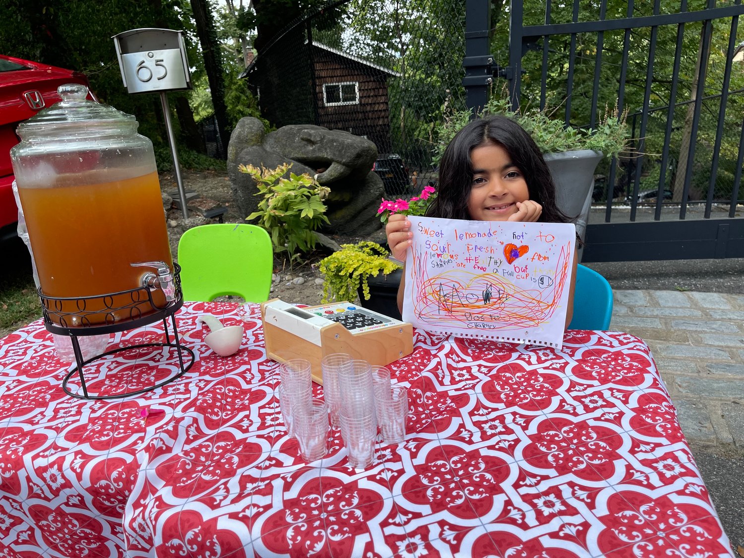 Seven-year-0ld Dahlia Balooch manned the cash register for both the lemonade and lemonade/iced tea stands, raising money for her four-legged friends.