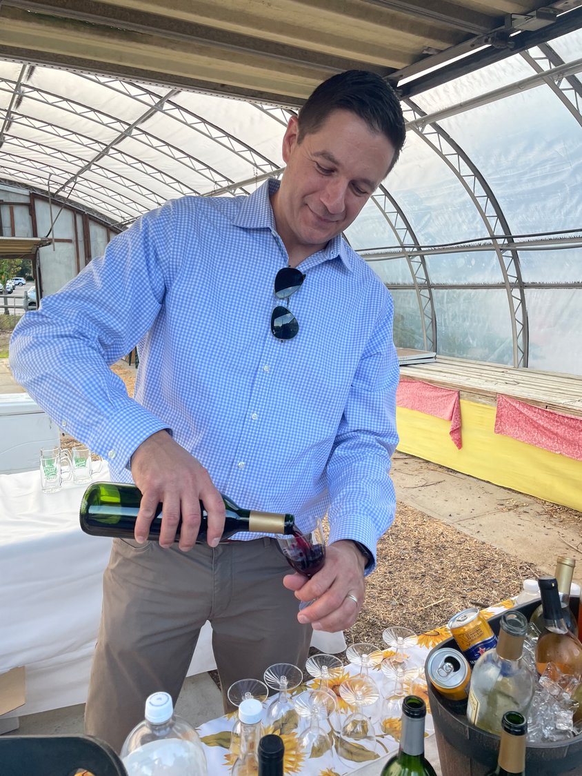 Malverne Trustee Carl Prizzi served drinks at Crossroad Farms’ annual farm to table benefit dinner, working out of a greenhouse-turned-bar.