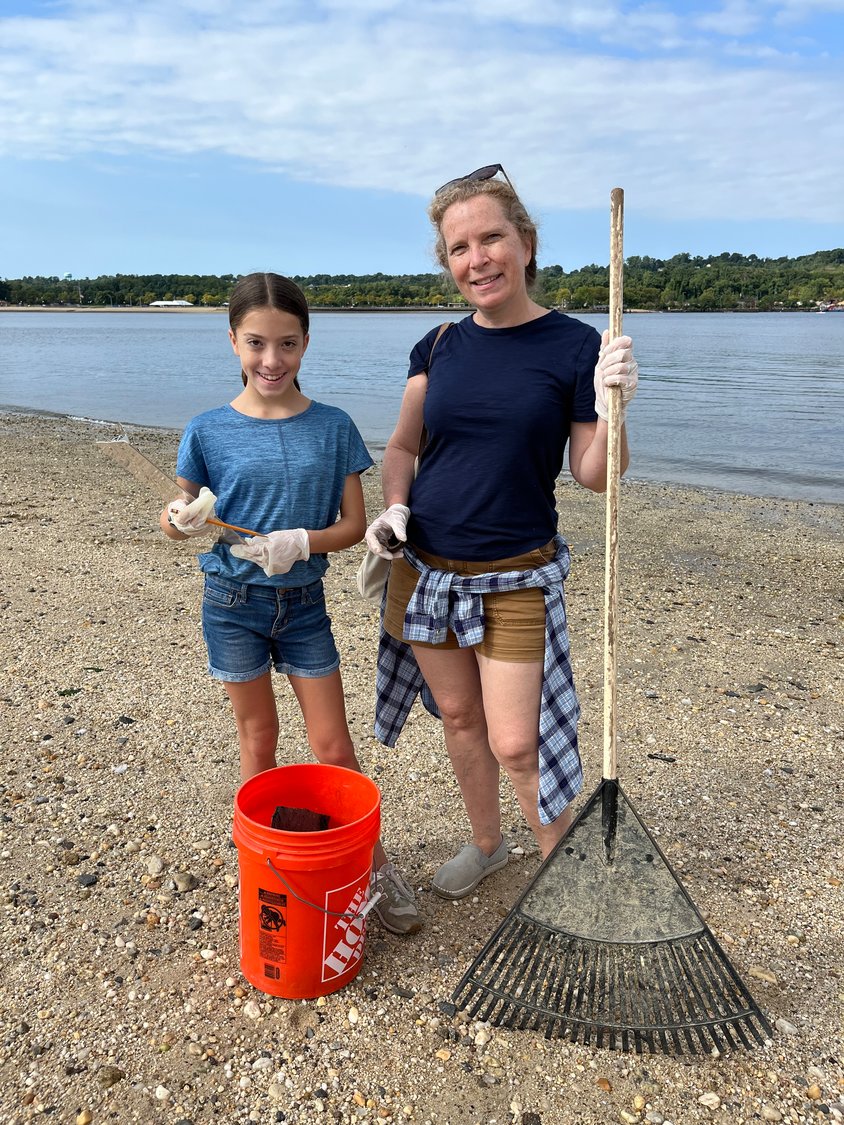 Lisa Lonigro, right, and her daughter Willow collected a bucketfulw of trash in the Coalition to Save Hempstead Harbor’s Coastal Cleanup.