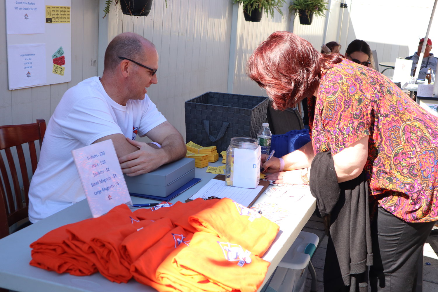 George Biegner sells merchandise and raffle tickets to help raise money for charity.
