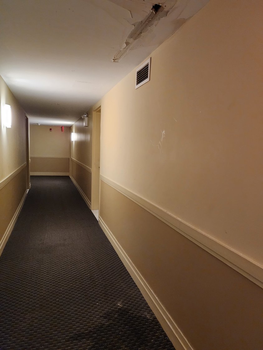 A leak in the ceiling outside an apartment is one of the many concerns residents have with the building’s infrastructure.