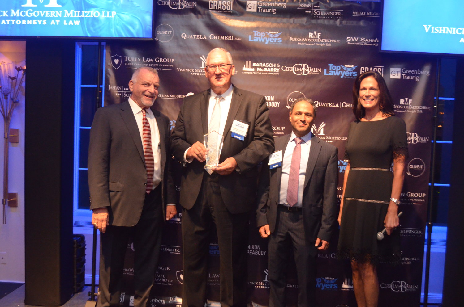 Cliff Richner and Host Judy Goss pose with Bernard McGovern and Morris Sabbagh from Vishnick McGovern Milizio LLP. Vishnick McGovern Milizio LLP won Top Law Firm (11-50 Employees).