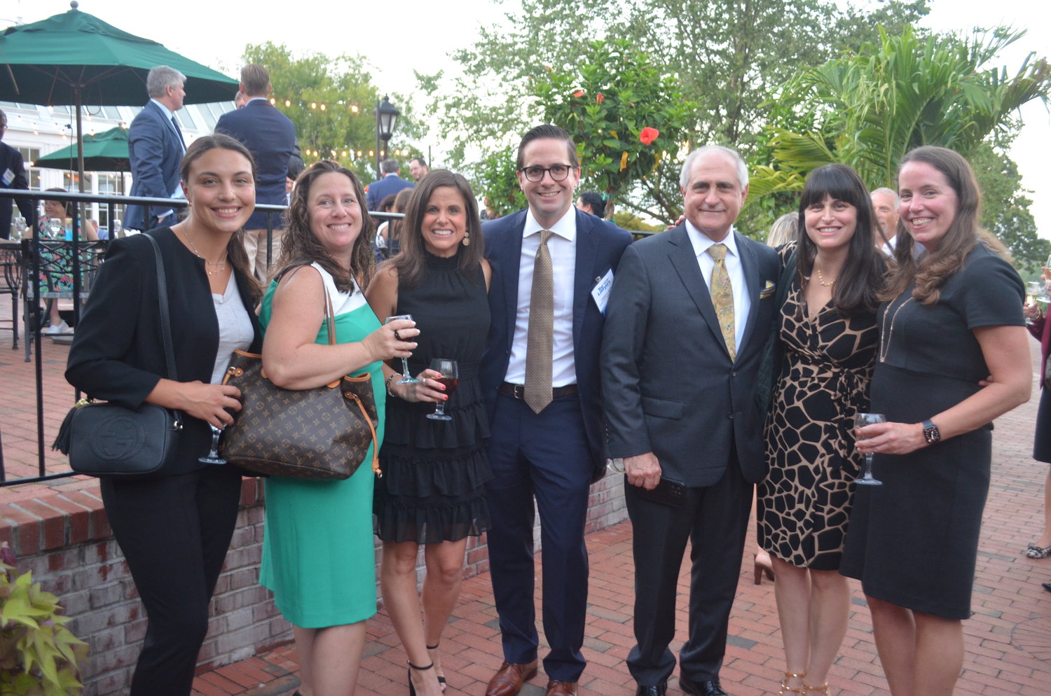 Jared Behr of Salenger, Sack, Kimmel & Bavaro LLP and guests strike a pose on the patio during the networking hour.
