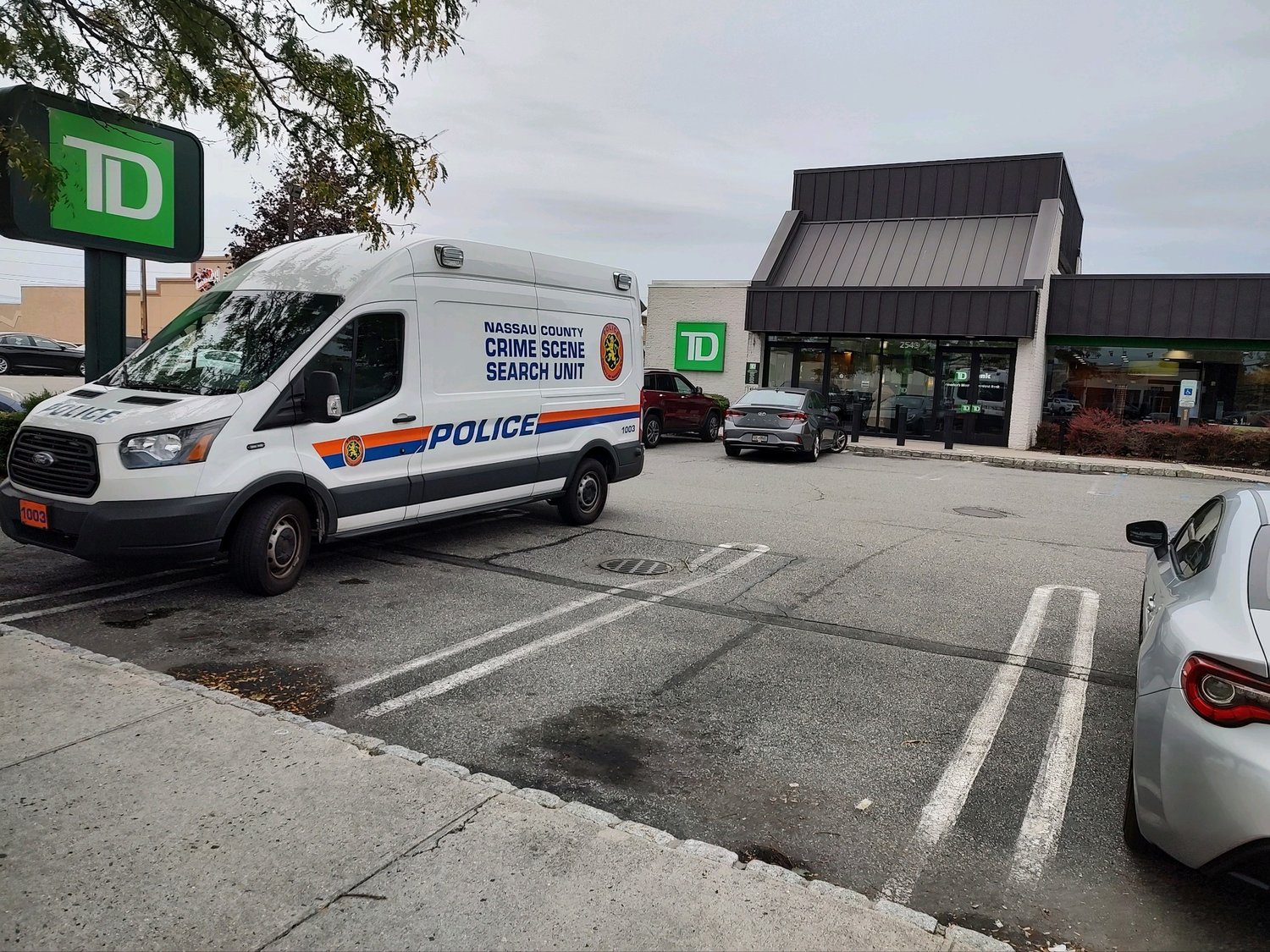Police were seen outside of the TD Bank on Hempstead Turnpike in East Meadow after an unknown man robbed the bank and fled on Sunday.