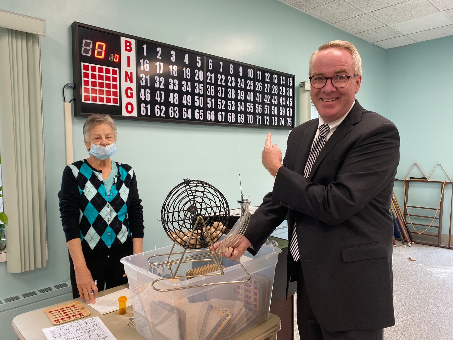 Town of Hempstead Supervisor Clavin showcased the new bingo machine next to the old hand-cranked machine.