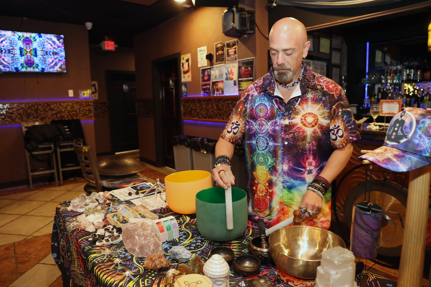 Kenny Cowie played a set of standing bells at G’s nightclub on Saturday. The event space held a psychic fair throughout the day. Cowie’s shirt denoted his belief in chakra meditation.