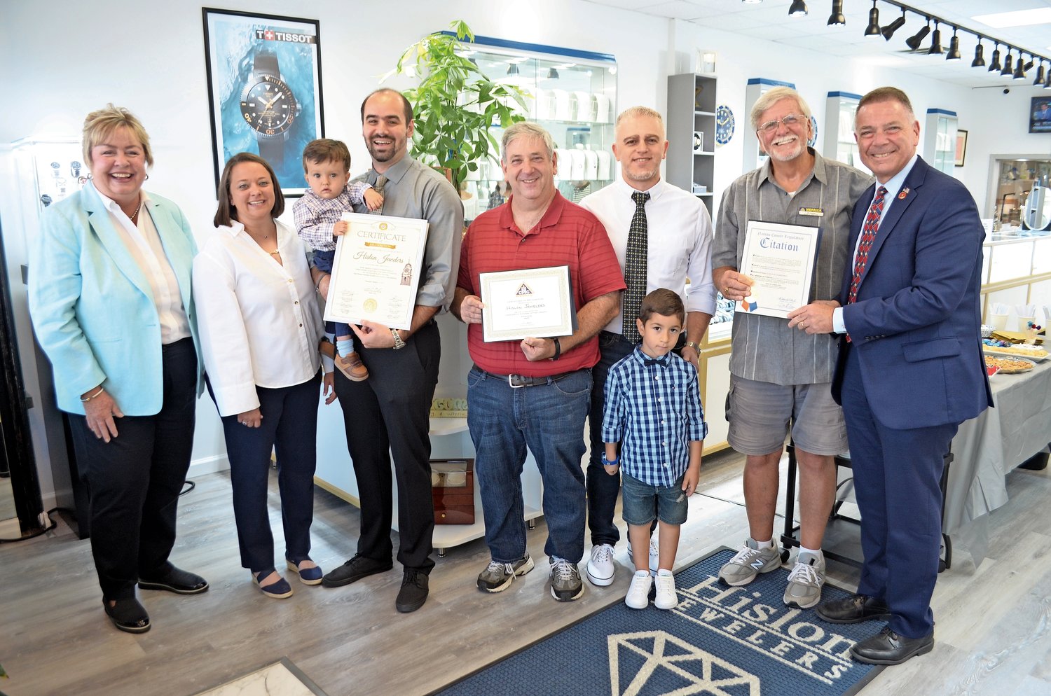 Hislon Jewelers on Merrick Road in  Merrick has its roots in the famous Hislon Watches, from Jeff Kaspar’s family. 

From left were Hempstead Town Clerk Kate Murray, Business and Marketing Manager and wife Adrien Ricci, son Rocco, owner Jeff Kaspar, President of the Merrick Chamber of Commerce Ira Reiter, jejweler Ibo and his son Ali, Merrick Chamber of Commerce member Joe Baker and County Legislator Steve Rhoads.