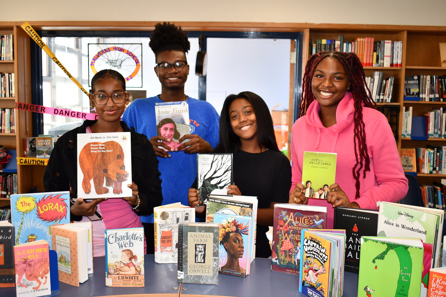 Students at Malverne High School with books that have historically or recently been challenged or banned. The display recognized the American Library Association’s Banned Books Week.