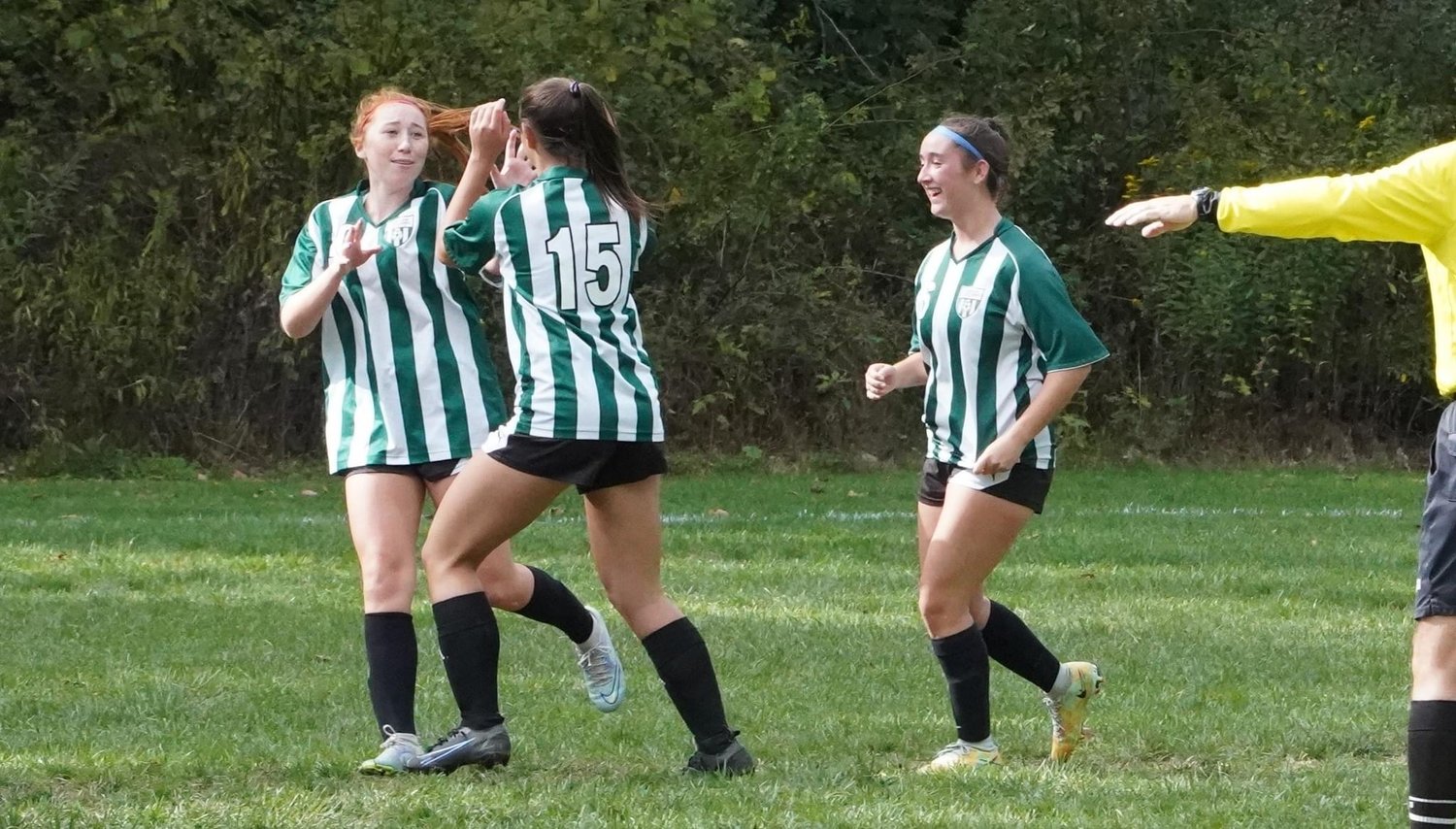 Gabby Meszaros, No. 15, scores a goal to open the Beekman Cup tournament before celebrating with teammates Avery Whitehouse and Kailey Dunne.