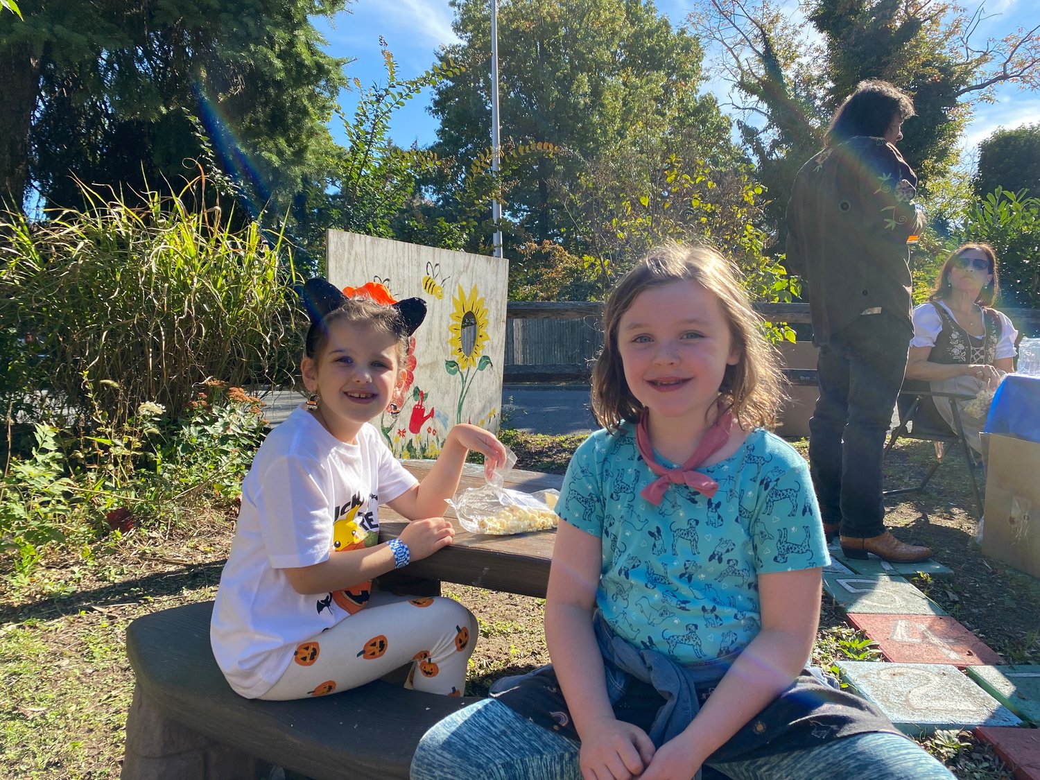 Stella Eberhart and Lucy Cain, of Baldwin, enjoyed games and popcorn at the civic association’s Oktoberfest and Marketplace.