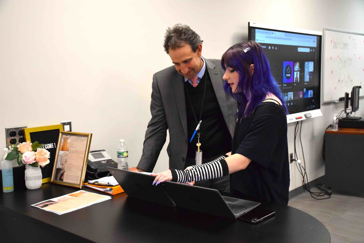 At the grand opening, Scott Bersin, the district’s assistant superintendent of instruction, learned about the booking platform that student Rebecca Rosensweige is using for the salon.