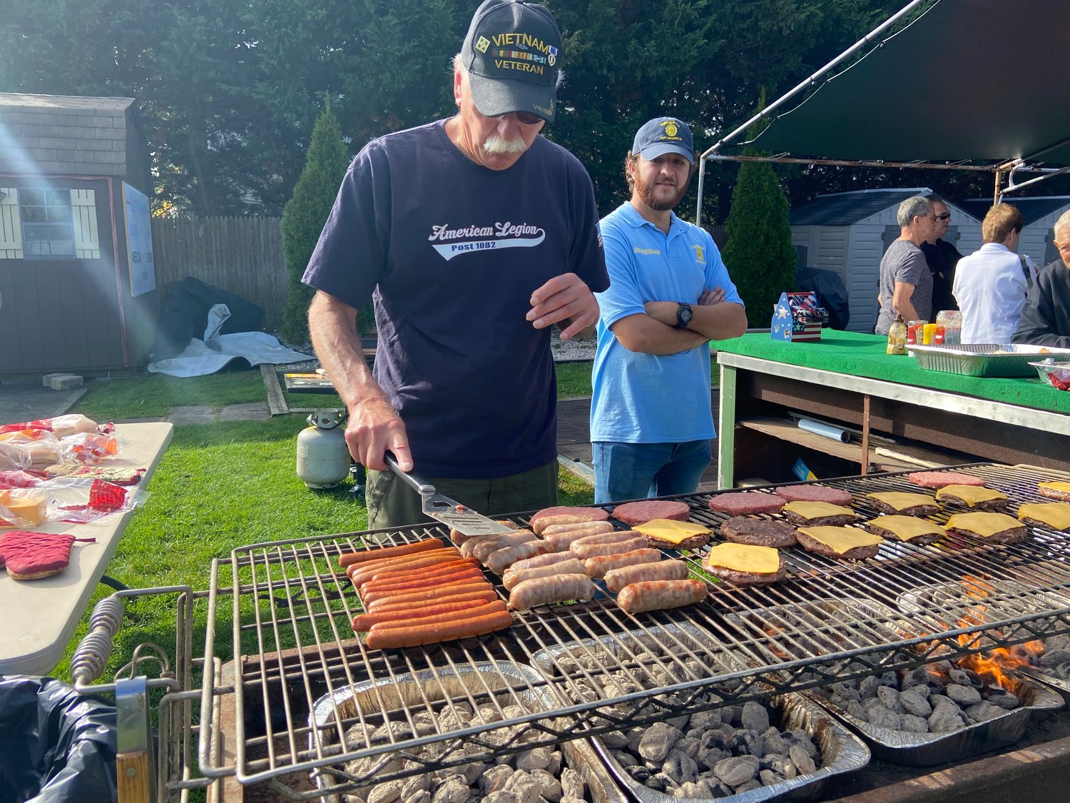 Dan Carbonare cooked up some burgers and dogs while Steven Papagni lent a helping hand.