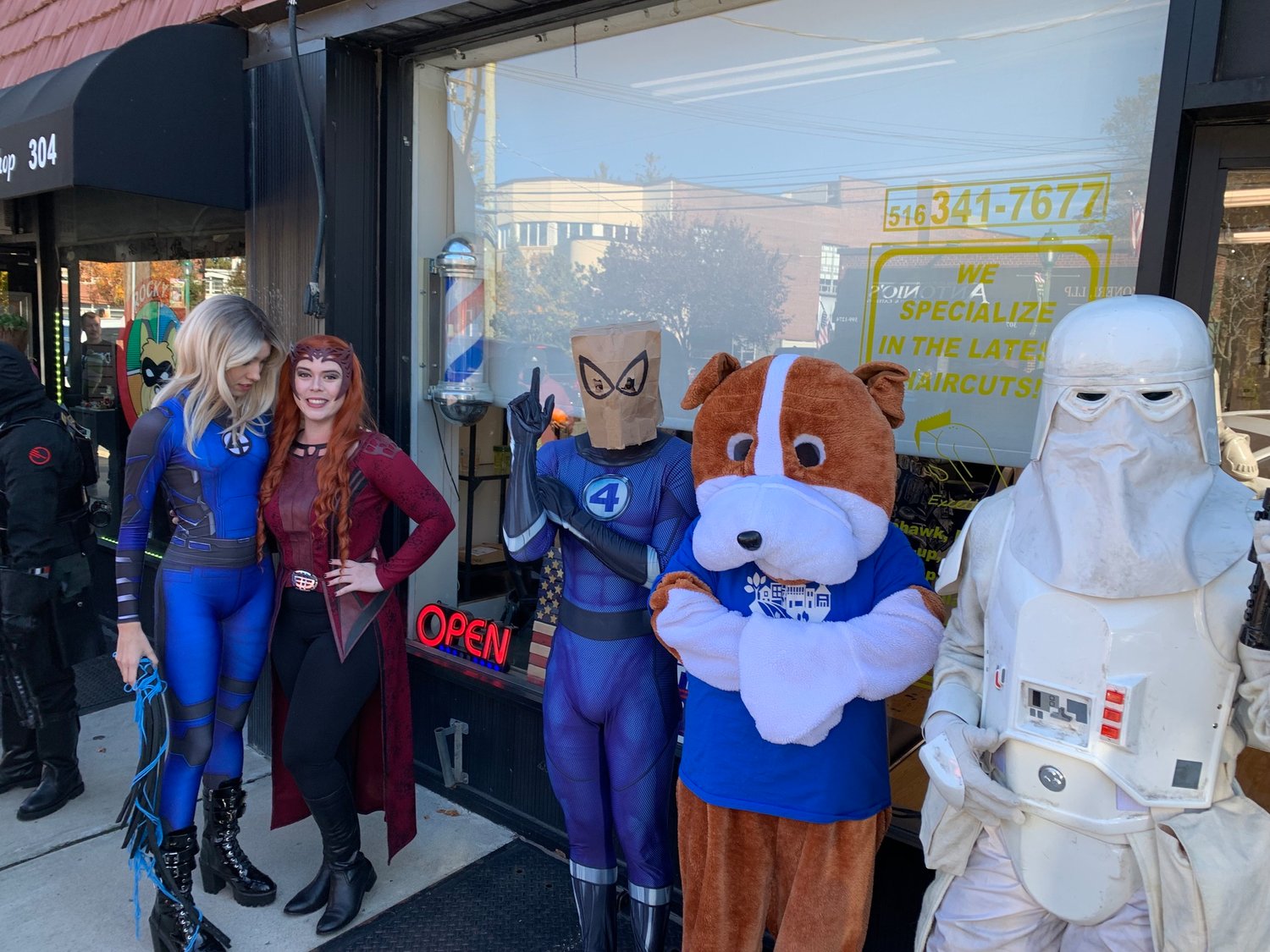 Cosplayers lined up in front of Rocky’s Comics for the store’s Halloween party as trick or treaters passed by on Hempstead Avenue. The comic shop closed its doors shortly after.