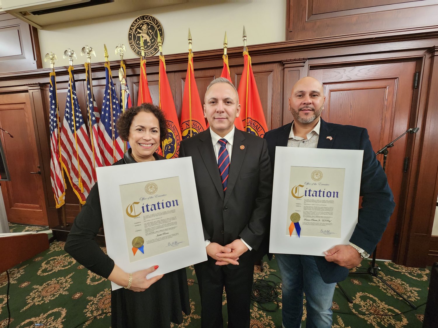 Judith Rivera and Ramon Pesentae Jr. received recognition for their community service in Glen Cove. With them was Herbert Flores, who presented Rivera and Pesentae with their citations.