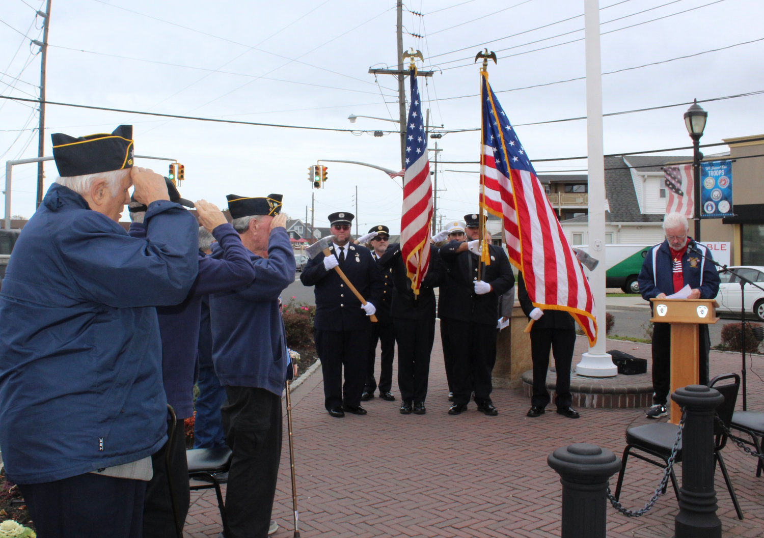 Island Park veterans saluted the flag as Bob Wilson spoke.