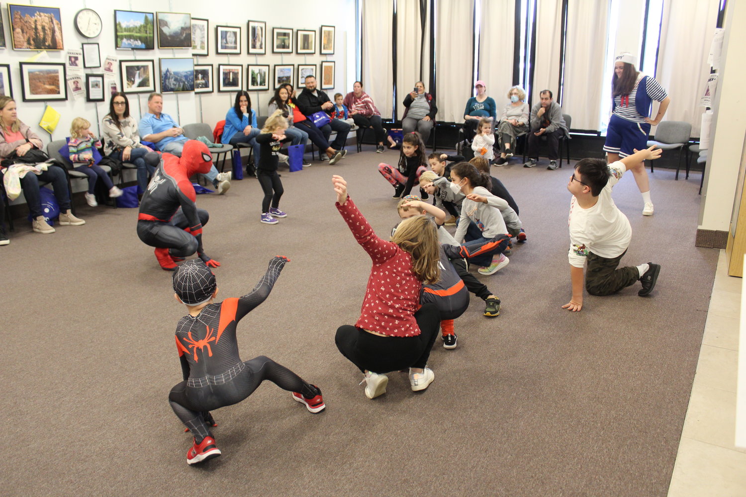Spiderman teaches kids how to do different Spiderman positions.