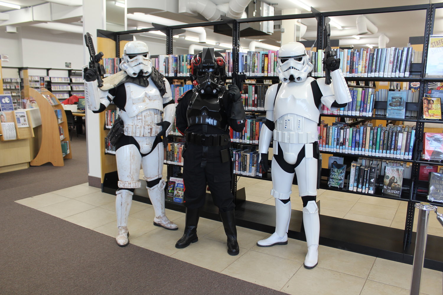 Stormtroopers Chris Feehan, Bret Chiarello and Kristina Murtha guard the Oceanside library’s books.