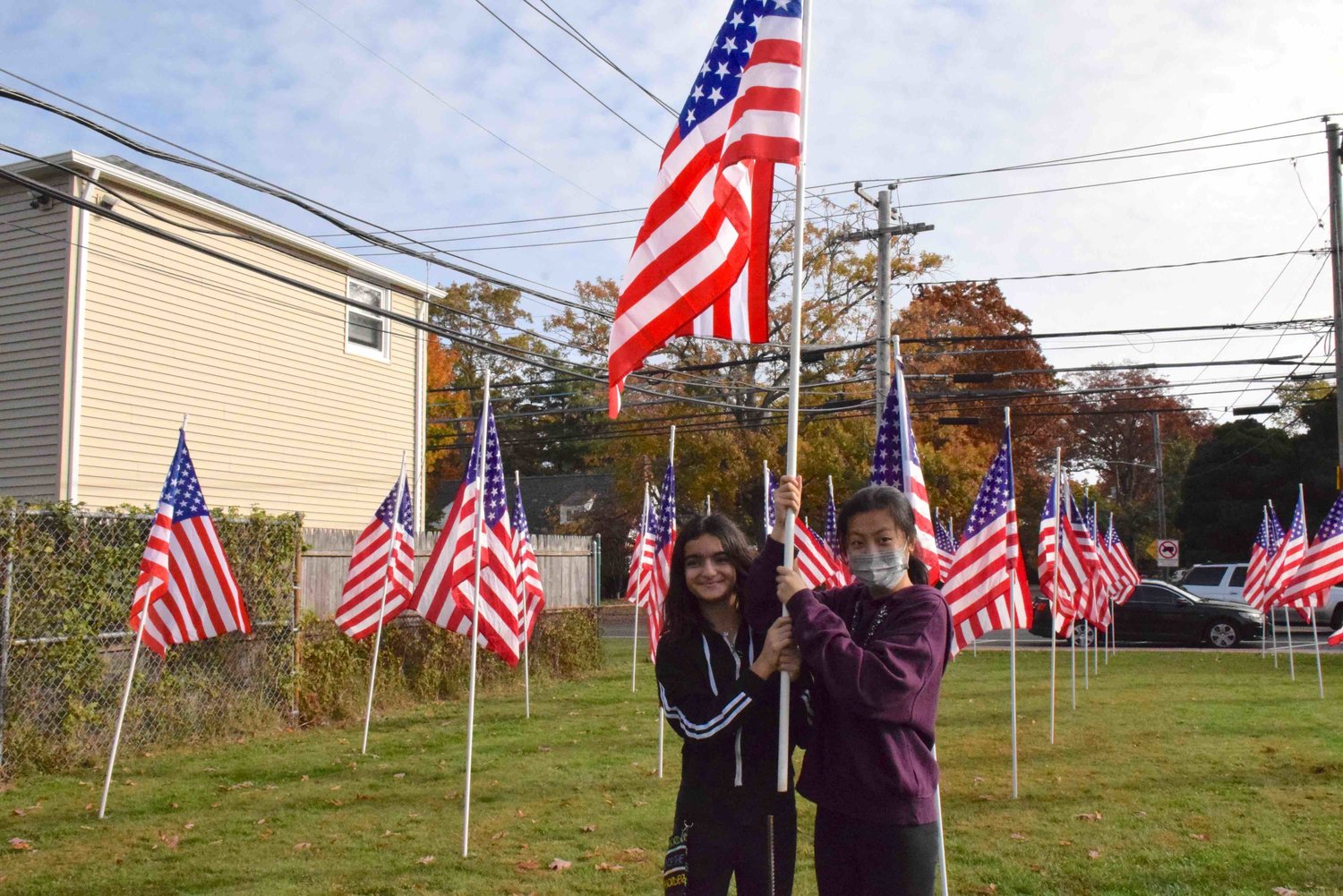 Gabby Nisanov and Youye Chen volunteered at Merrick Avenue’s flag installation on Nov. 5.