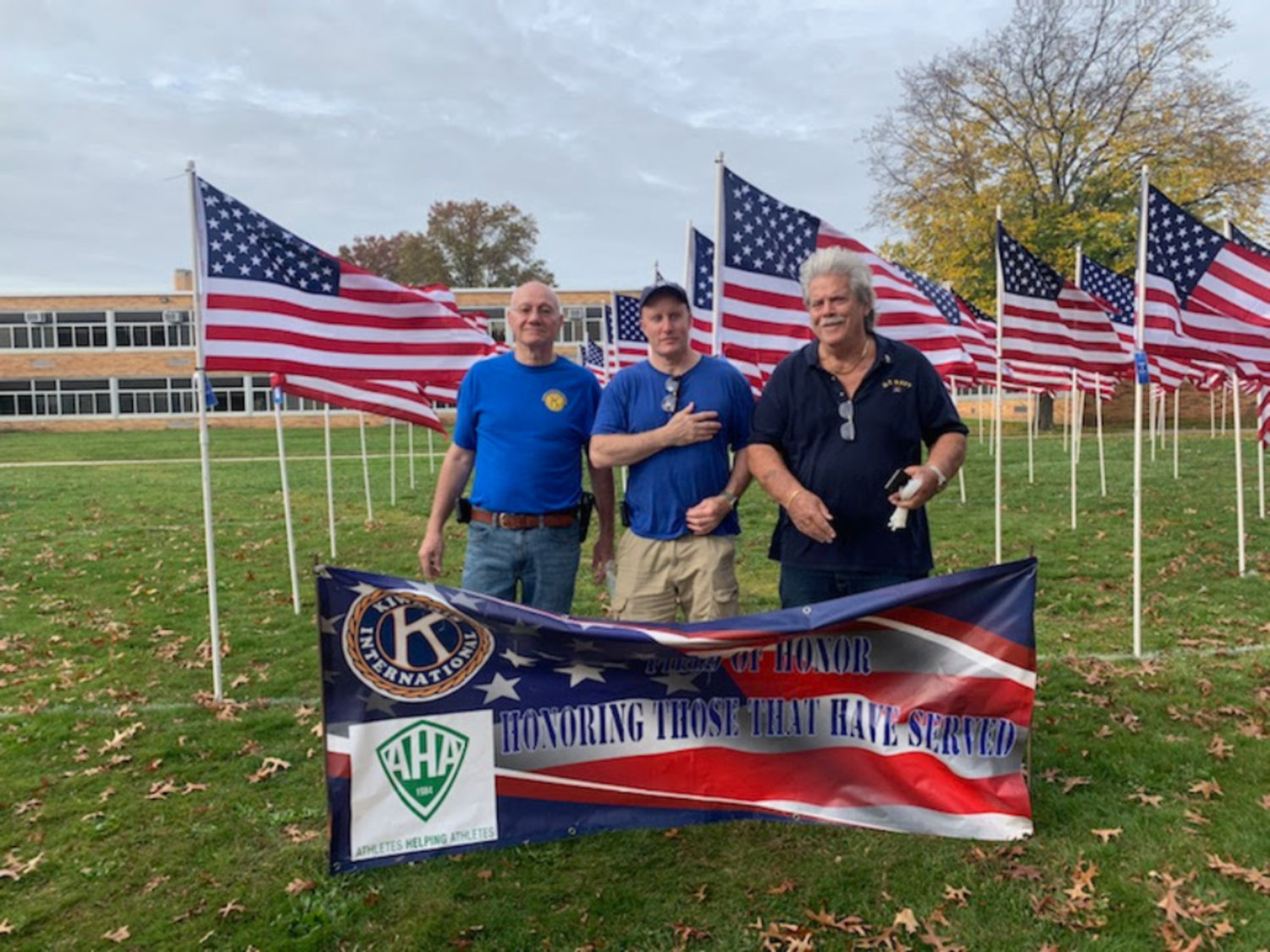 Steve LaSala, Brian O’Flaherty, and Richie Krug Sr., helped put up the Field of Honor flags at East Meadow High School.