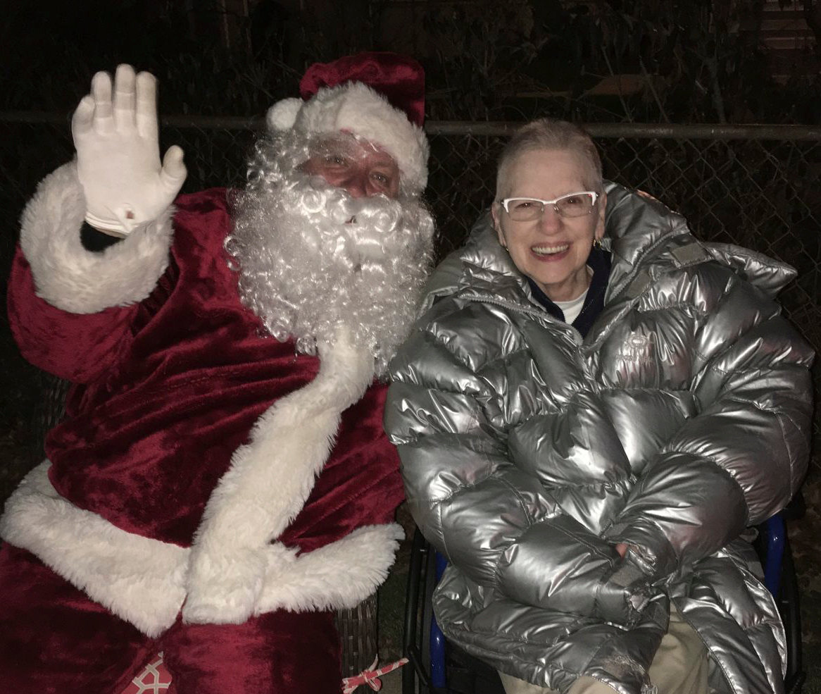The late Joan Giles, Katherine Blazdell’s mother, took a photo in front of her lit 85-foot tree with a member of the fire department dressed as Santa on their Santa route during the holidays in previous years.