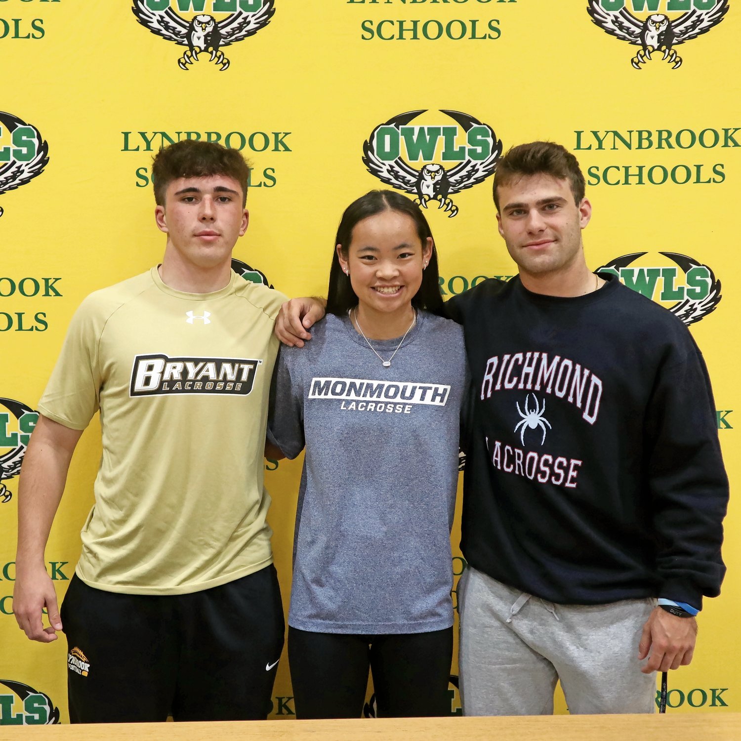From left, Lynbrook High School athletes Max Dantona, Sara Curley and Michael Fagen signed letters of intent to play at various universities on Nov. 9.
