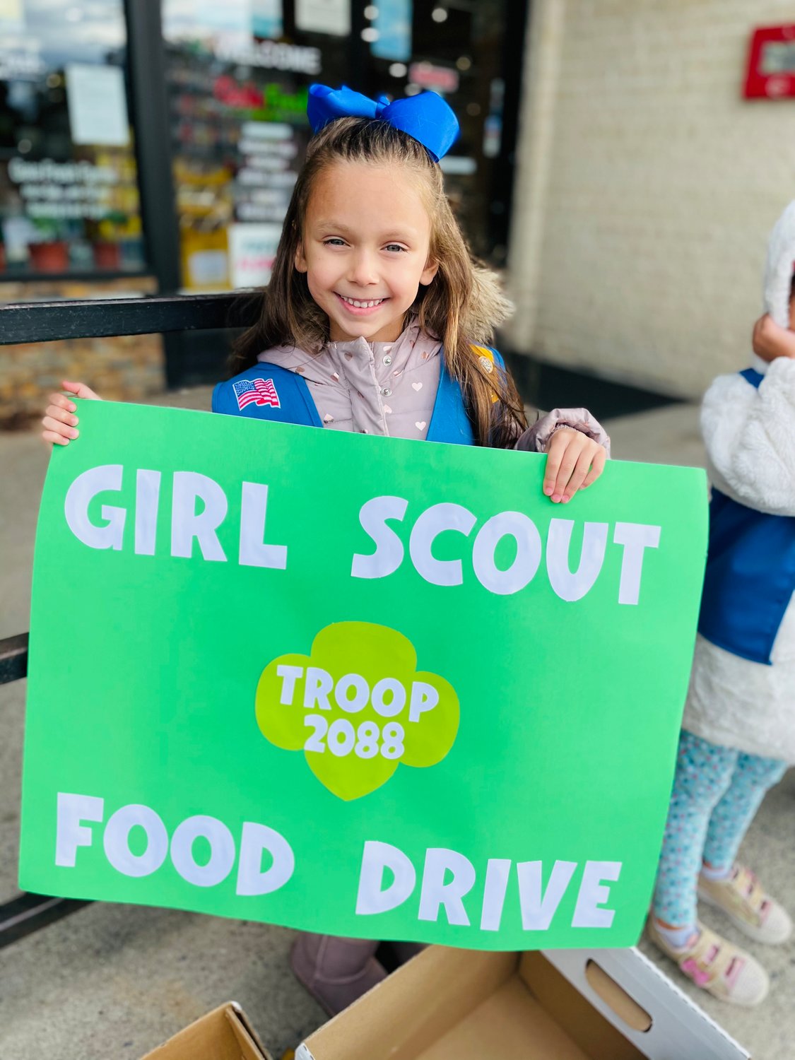 Kaylee Ricca, of Girl Scout Troop 2088, helped collect food for the needy this Thanksgiving.