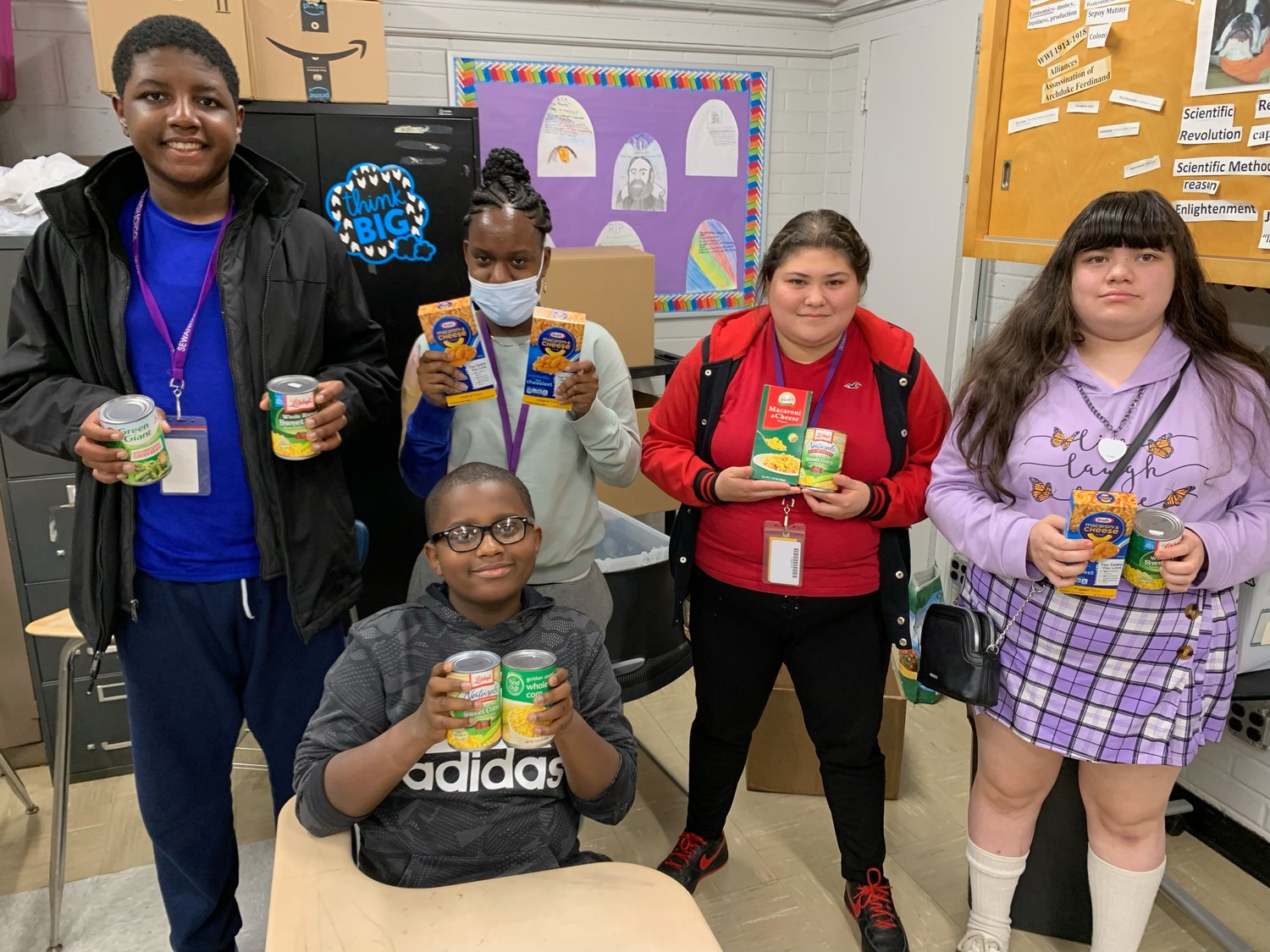 Sewanhaka High School students Andrew Baptiste, left, Grace Toussaint, Sebastian Ulysses Jocelyn Galdamez and Kathleen Galdamez with items collected for the Thanksgiving food drive.