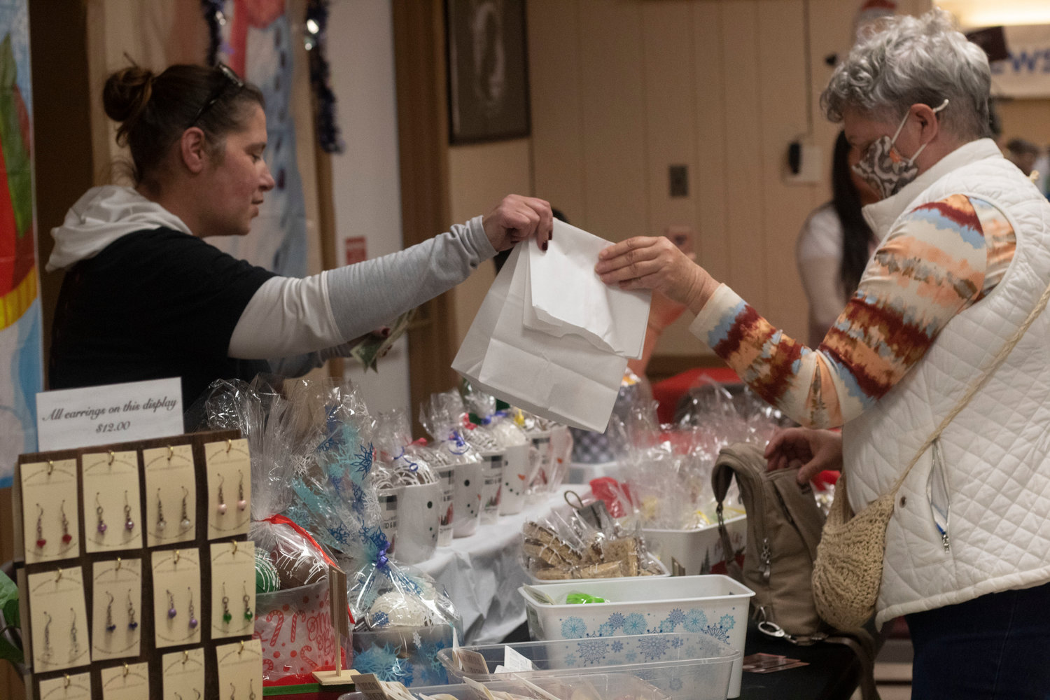 Louann Sherbach of Amityville (right) going home with a one-of-a-kind homemade gift from Alyssa Bianco, owner of Sweets & Treats (left).