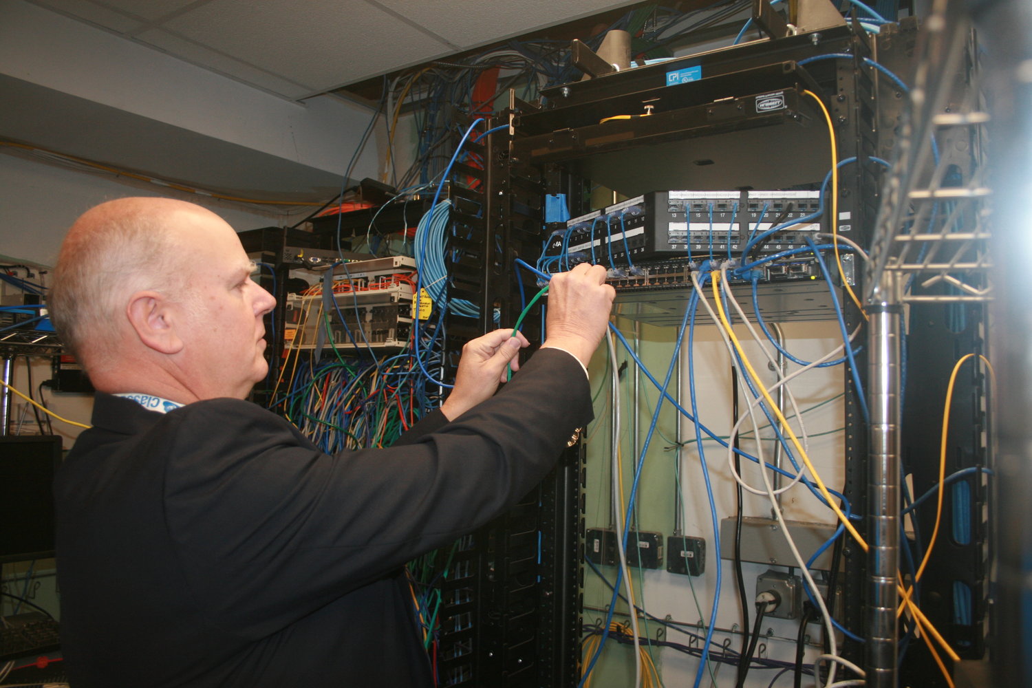 West Hempstead School District Director of Technology Vincent Fleck examines equipment at the middle school. Ensuring that the network is secure is a constant endeavor.