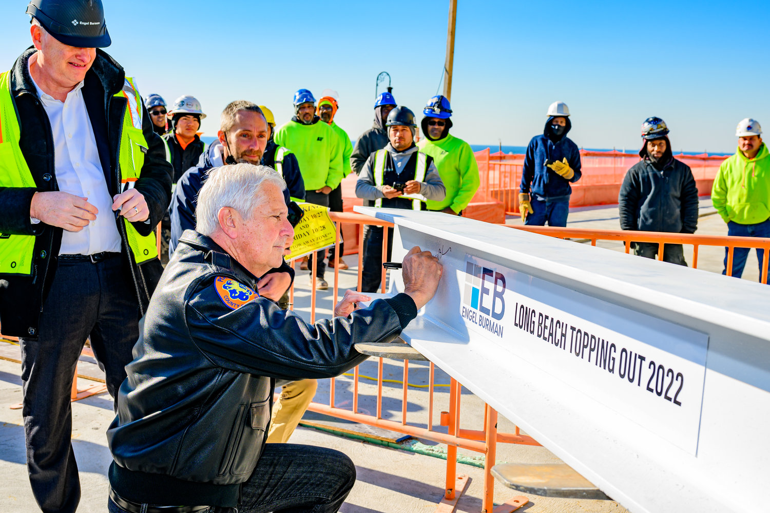 Nassau County Executive Bruce Blakeman wrote his name on a steel beam that was hoisted to the top of one of the three residential buildings under construction on the Superblock.